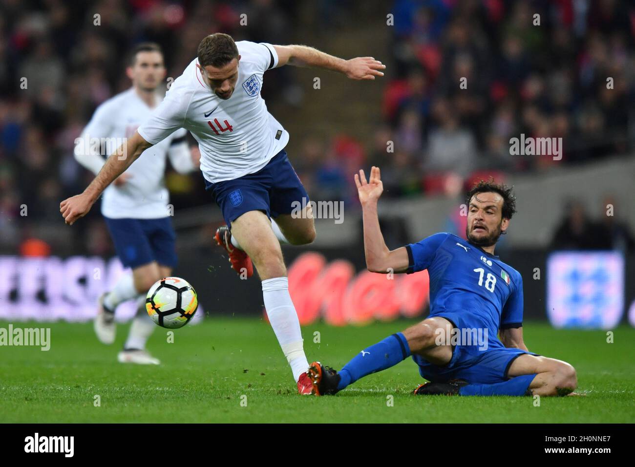 England’s Jordan Henderson is tackled by Italy’s Marco Parolo Stock Photo