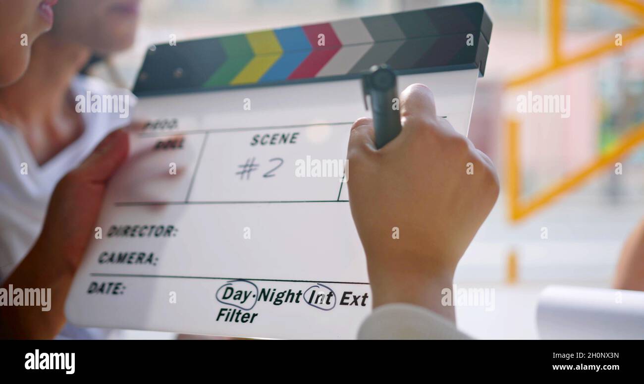 Hand is writing on a cinema clapperboard Stock Photo