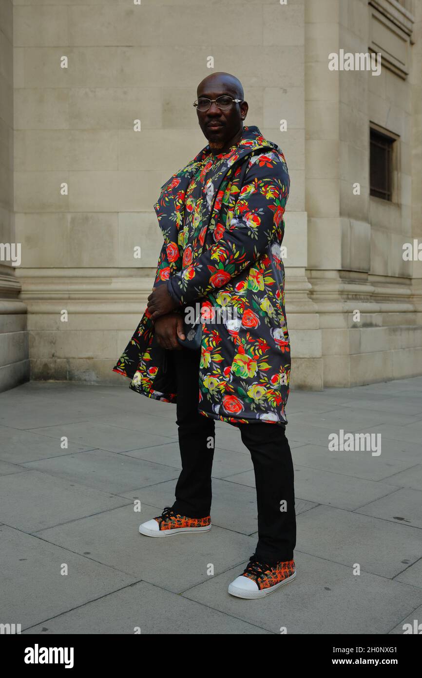 London (UK): 2021 Africa Fashion Week. Out and about, attendees pose for the camera outside Freemasons Hall where the Africa fashion event was held. Stock Photo