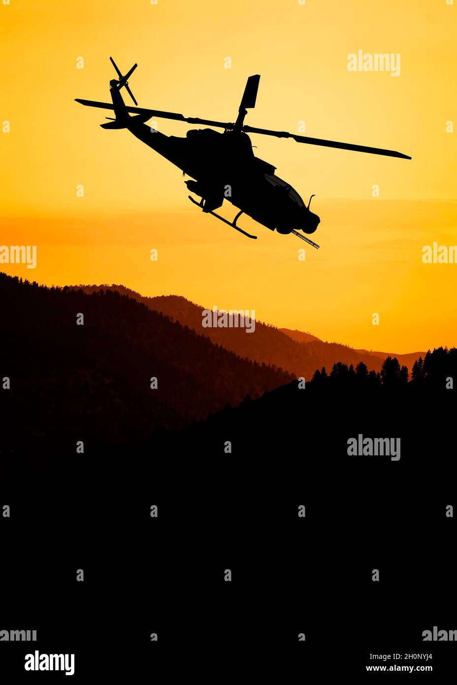 American attack helicopter silhouette in the flight Stock Photo