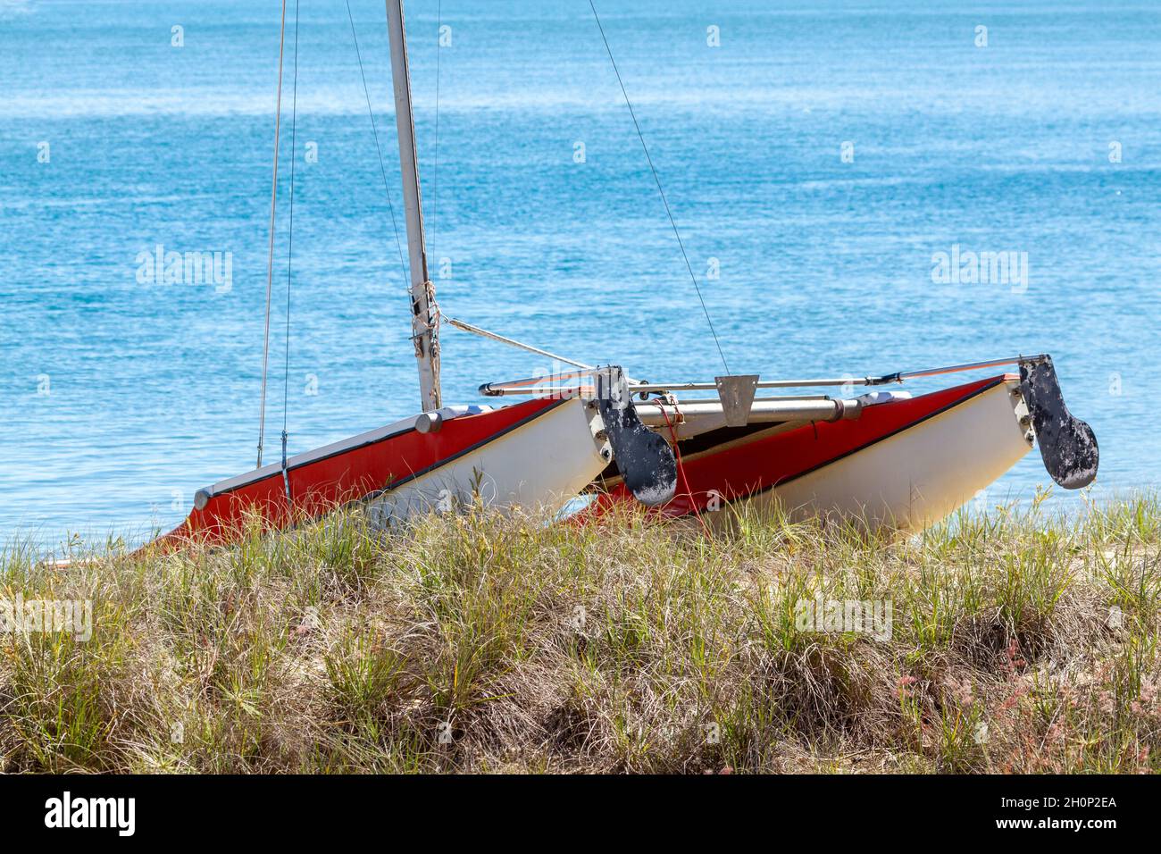 A catamaran at rest on sand dune. Stock Photo