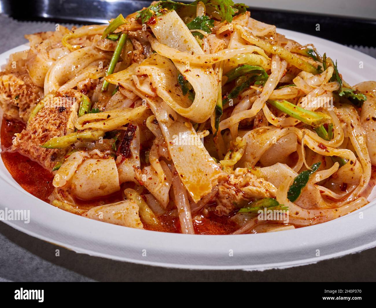 Handmade noodles in spicy sauce from Tarim Uyghur Cuisine in the New World Mall, Flushing, Queens, NY, USA Stock Photo