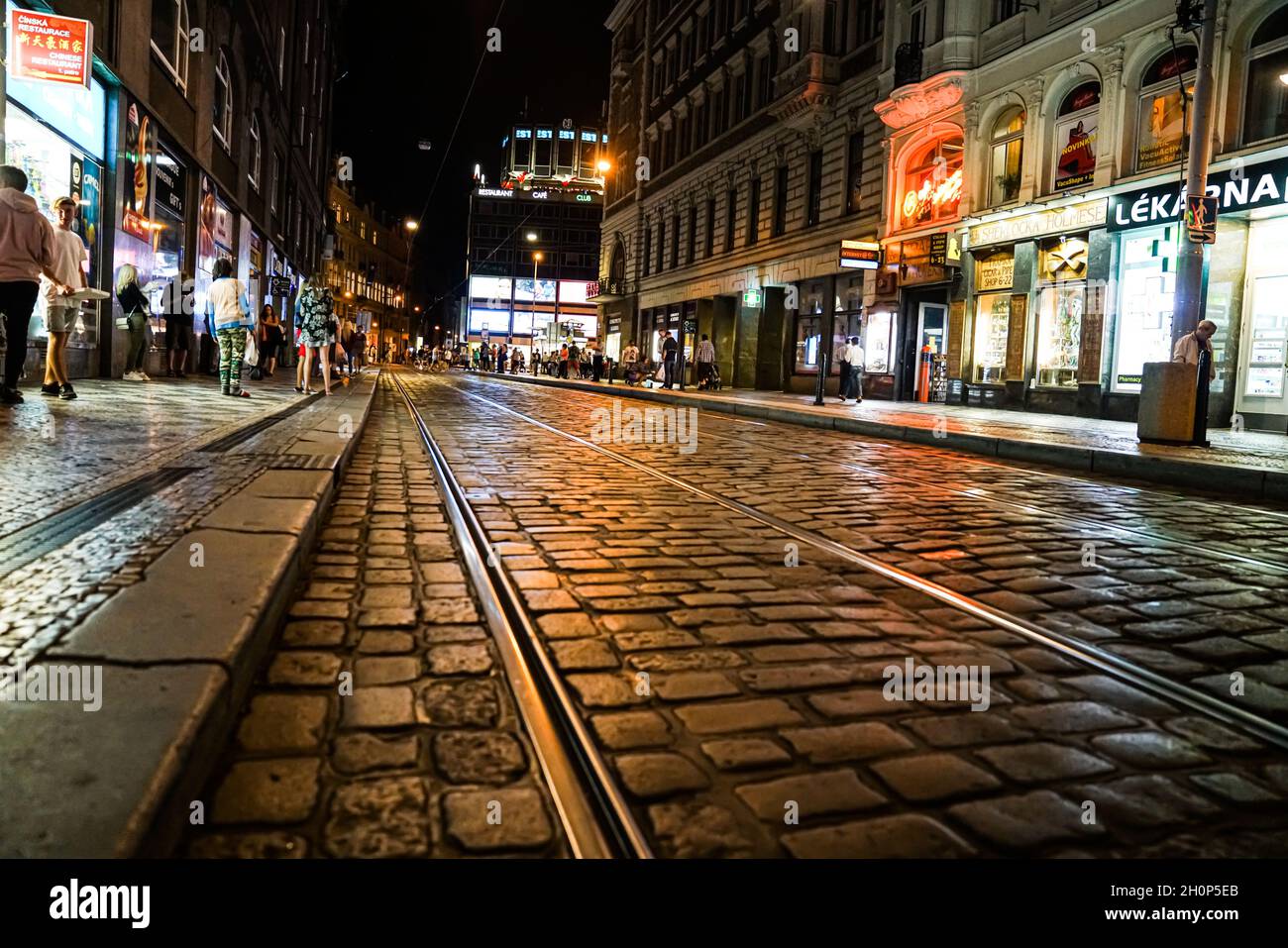 Prague Czech Republic -August 30 2017; Street at night in the city with  light glistening off cobbles and tram lines leading through town and people  wa Stock Photo - Alamy