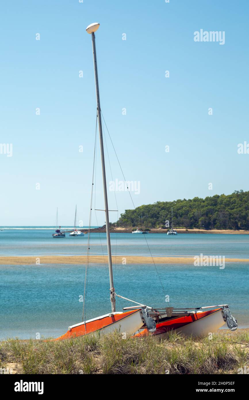 A catamaran at rest on sand dune. Stock Photo