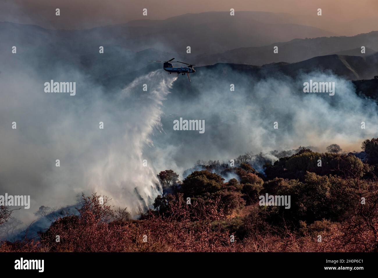 Gaviota, California, USA. 13th Oct, 2021. A Chinook firefighting helicopter, makes a water drop along the Refugio Canyon ridge line Wednesday afternoon. The blaze has burned 15,000 acres. (Credit Image: © Erick Madrid/ZUMA Press Wire) Stock Photo