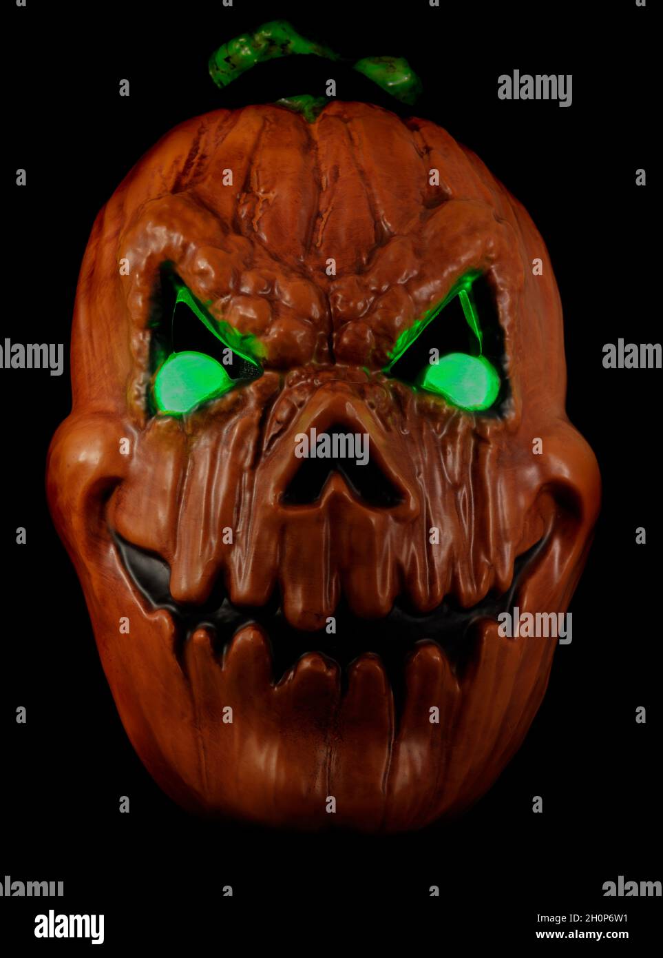 Light-Up Evil Eyes Jack-o'-Lantern Face Mask Isolated gainst Black Background Stock Photo
