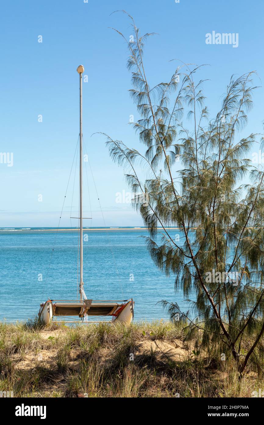 A catamaran at rest on sand dune. Stock Photo