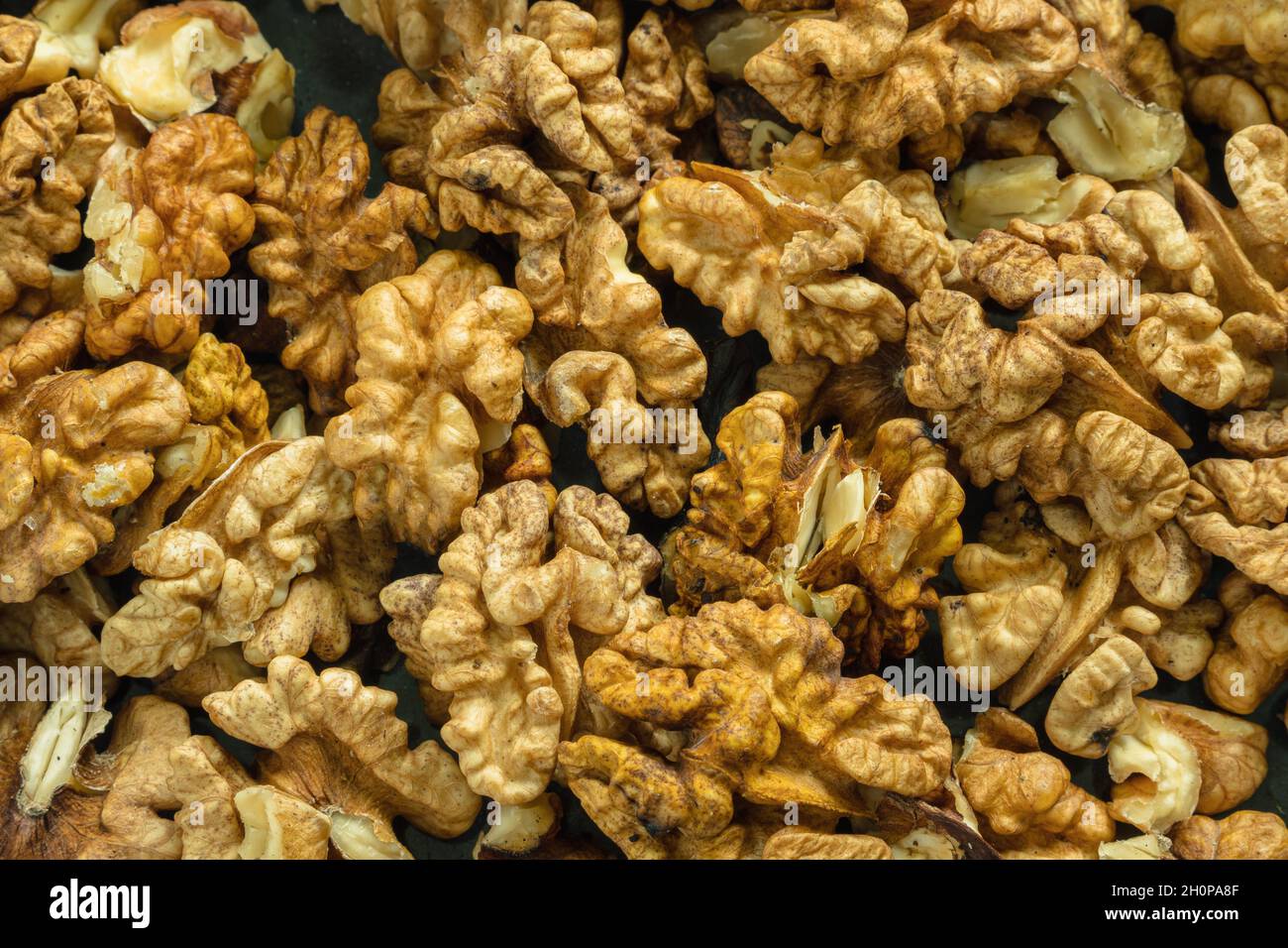 Top view of the halves of peeled walnuts. Close-up. Background image Stock Photo