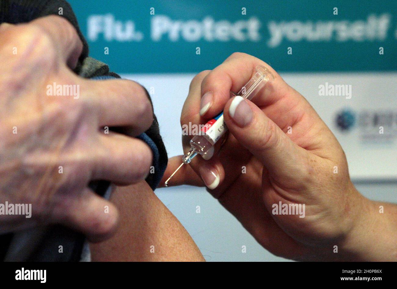 File photo dated 05/10/09 of a person getting a flu jab as the NHS continues to push ahead with its biggest ever flu campaign amid fears that if the viral infection is left unchecked this winter then thousands of lives could be lost. Dr Nikki Kanani, medical director of primary care at NHS England, said: 'This year it is more vital than ever that all children and eligible adults take up the offer of the free vaccine, as we head into one of the most challenging winters yet for the NHS'. Stock Photo