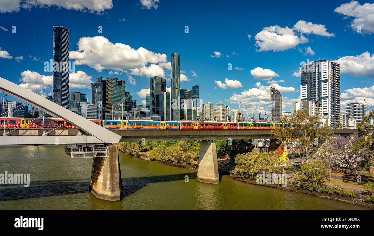 Brisbane, Queensland, Australia - Colourful train crossing the Brisbane river Stock Photo