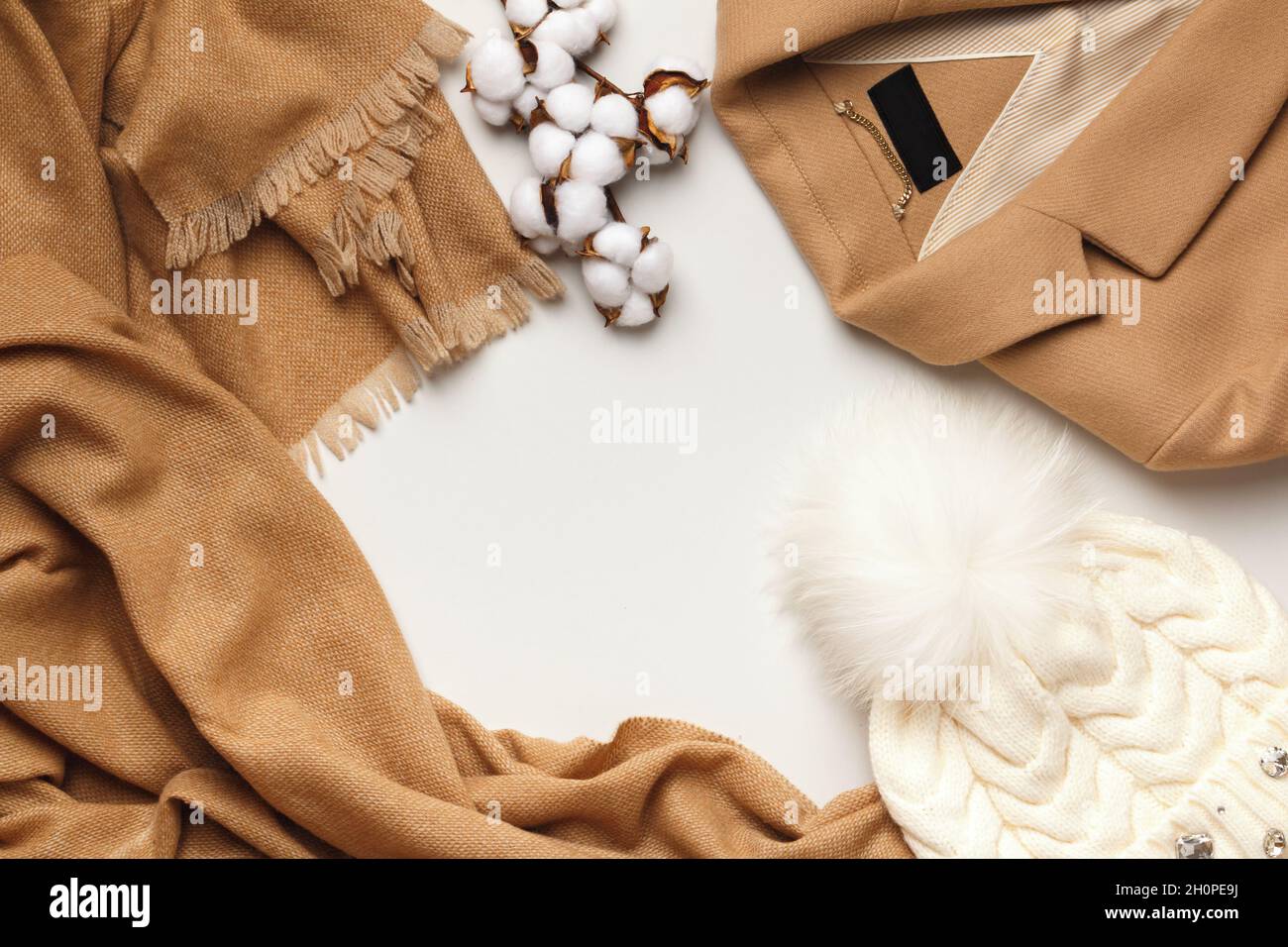 Warm autumn-winter clothes on a light gray background. Scarf coat hat. Flat lay top view copy space Stock Photo