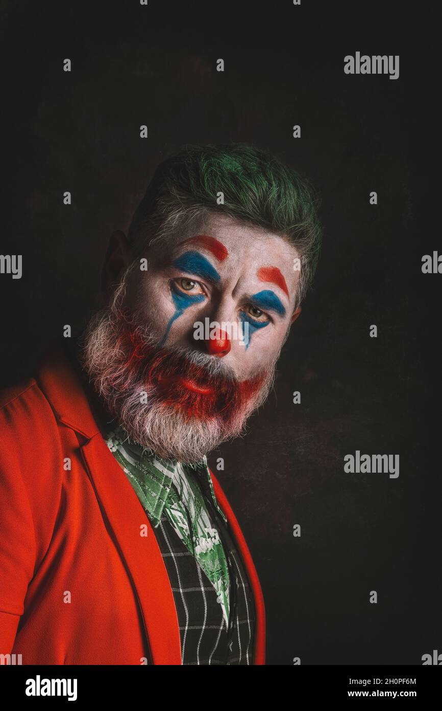 Male portrait that imitates the Joker. The clown makeup and green hair. Cosplay. hallowen Stock Photo