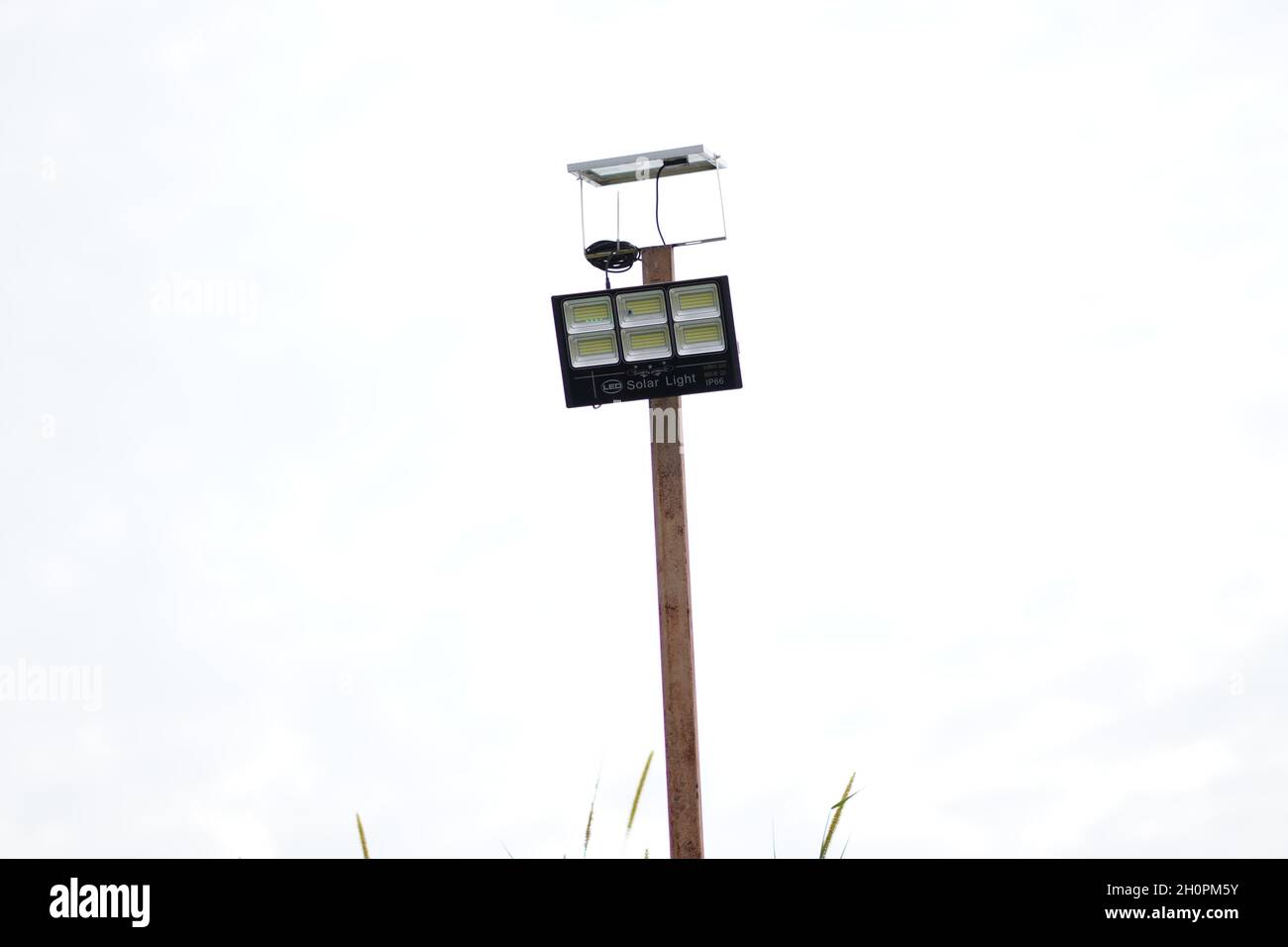 A solar sport light was installed on a pole to light the coverage area at night. The solar sport light is used to light the construction store at night. Stock Photo