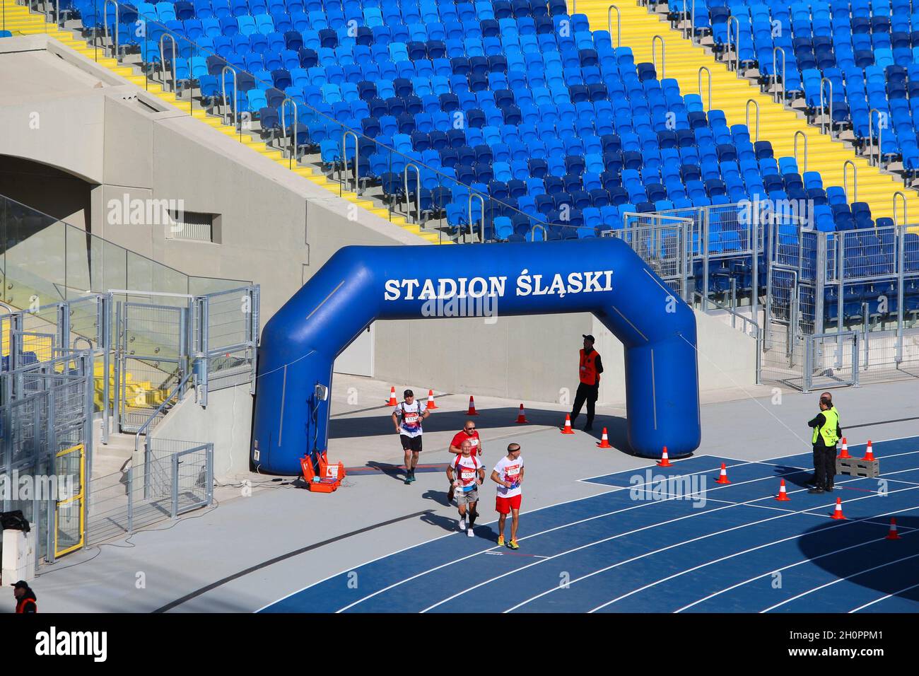 KATOWICE, POLAND - OCTOBER 1, 2017: Runners finish the PKO Silesia Marathon at Silesian Stadium (Stadion Slaski) in Katowice, Poland. The marathon had Stock Photo