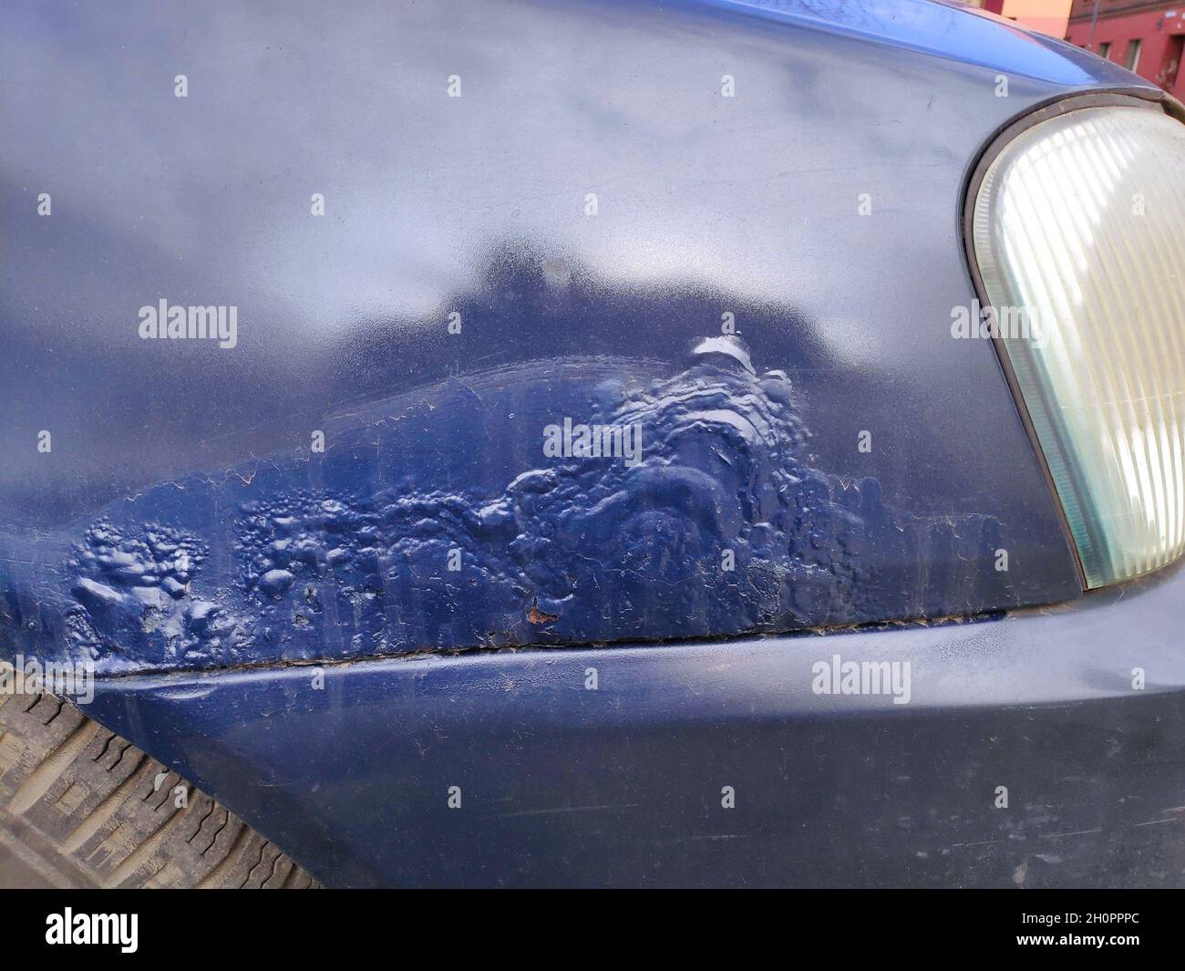 Rusting front wing in an old car. Weather damage in vehicle. Stock Photo