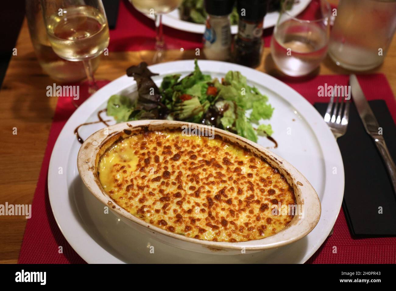 Seafood and potato gratine in France. French food. Cuisine of France. Stock Photo