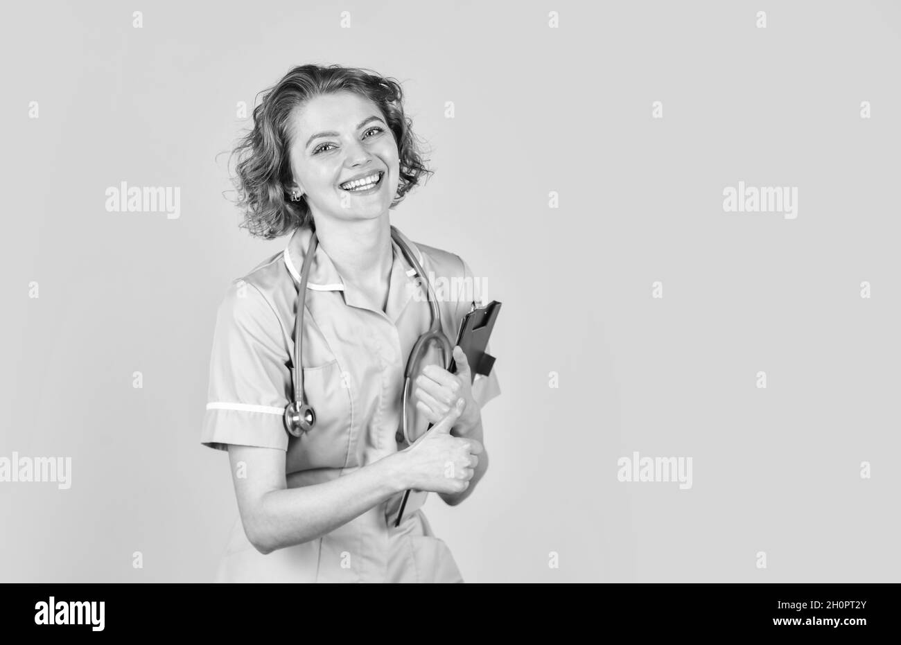 doctor standing with stethoscope at hospital. woman doctor with folder. medical doctor hold folder. nurse holding patient medical chart. Nurse holding Stock Photo