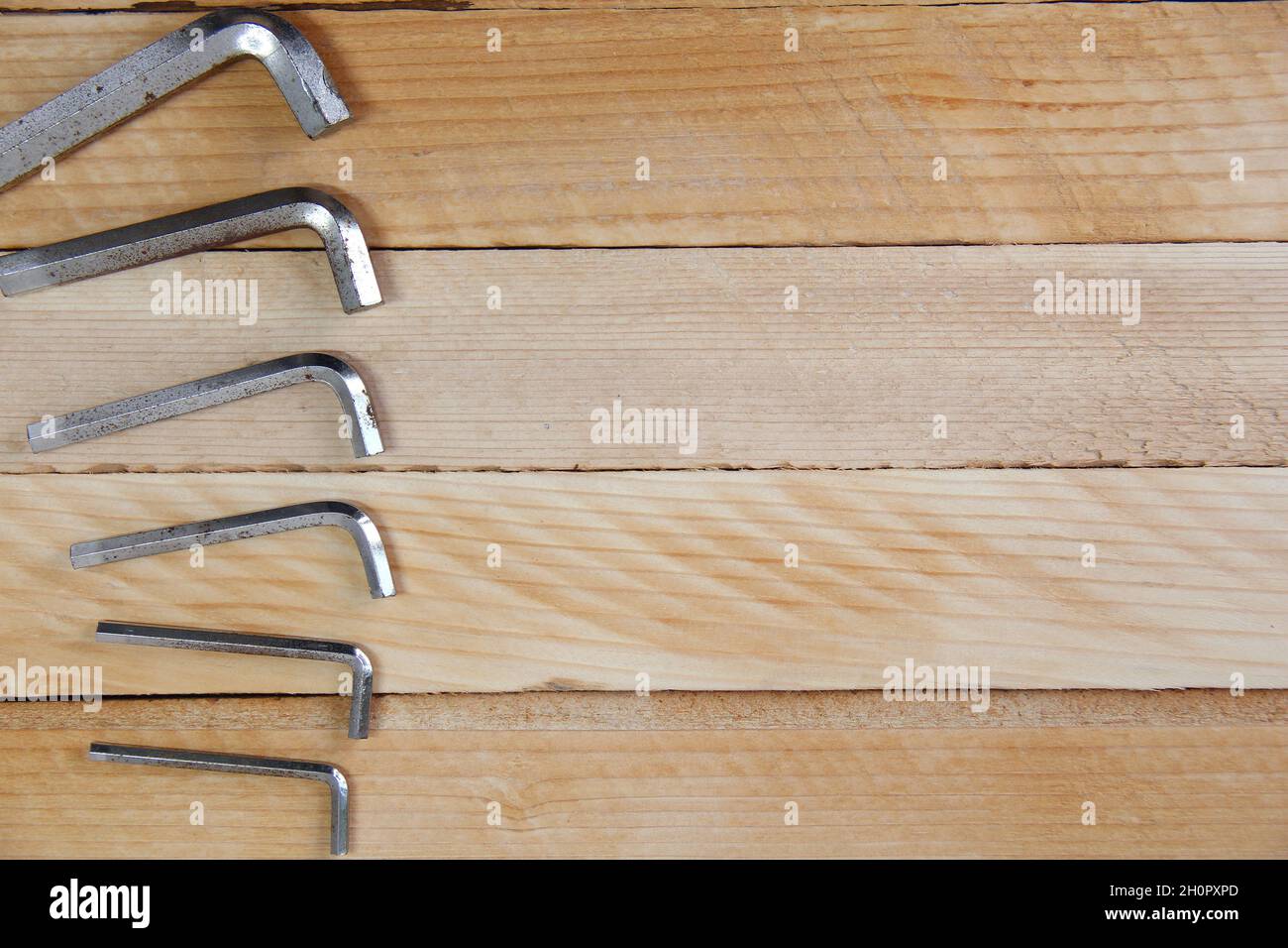 Set of hex keys laid out in ascending order on the wooden background