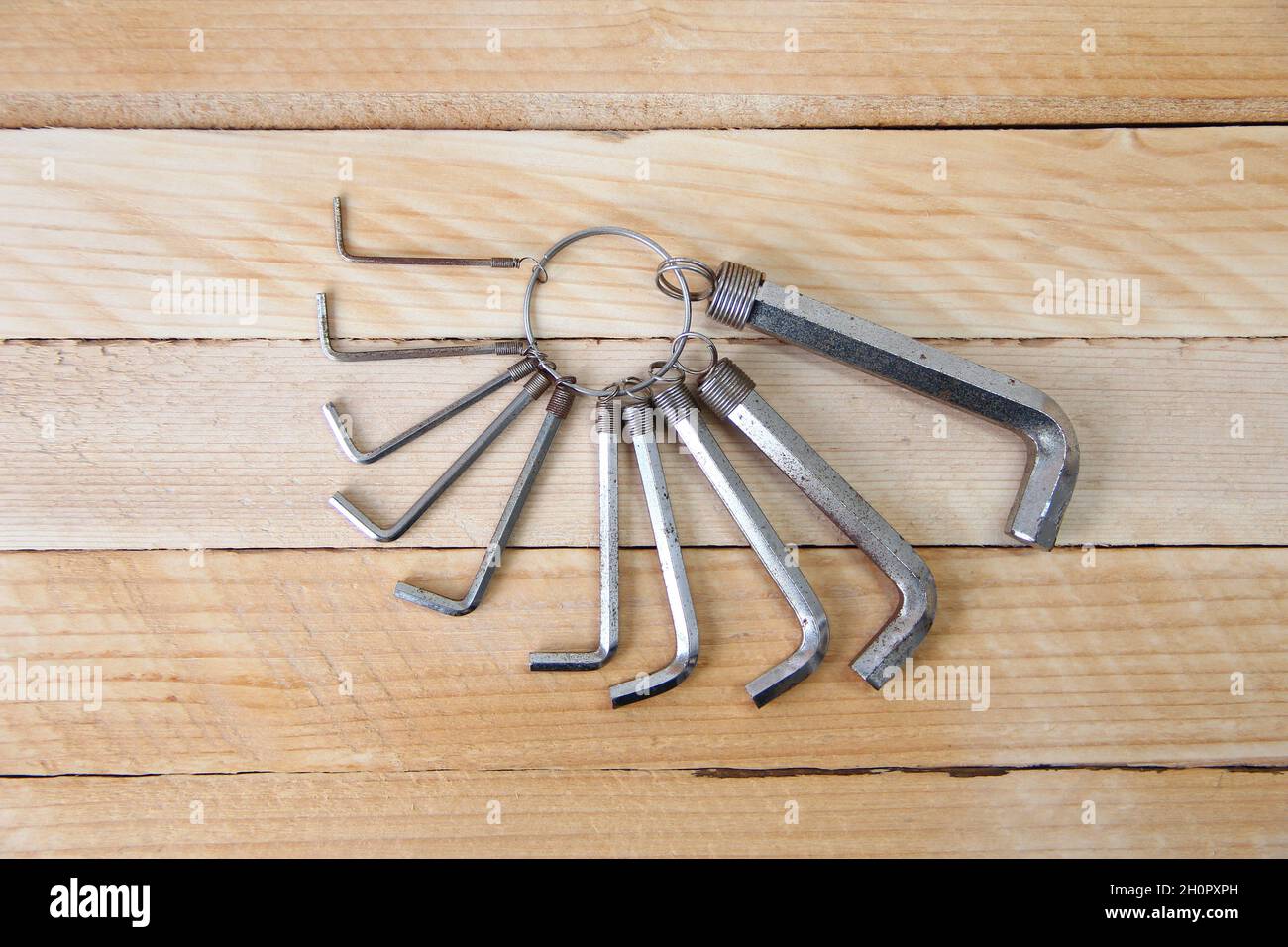 Set of hex keys on a ring on the wooden background Stock Photo