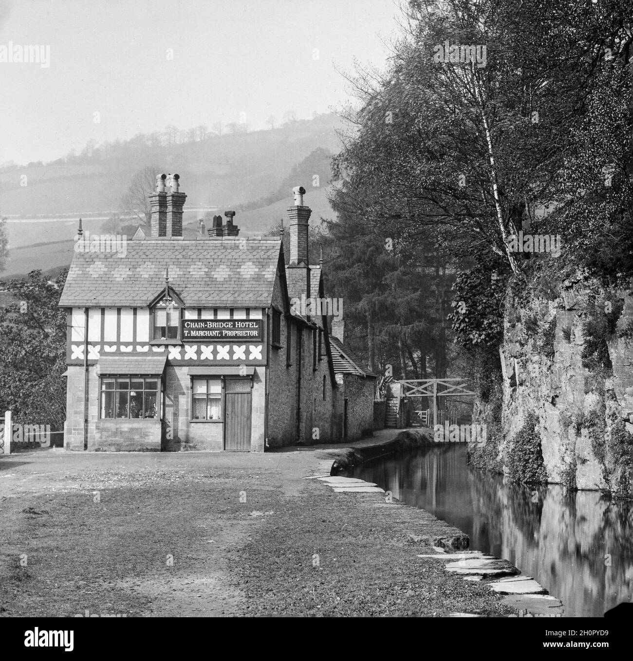 Vintage early 20th Century black and white photograph showing the Chain Bridge Hotel or Chainbridge Hotel on the River Dee,near the town of Llangollen in Wales, UK. Stock Photo
