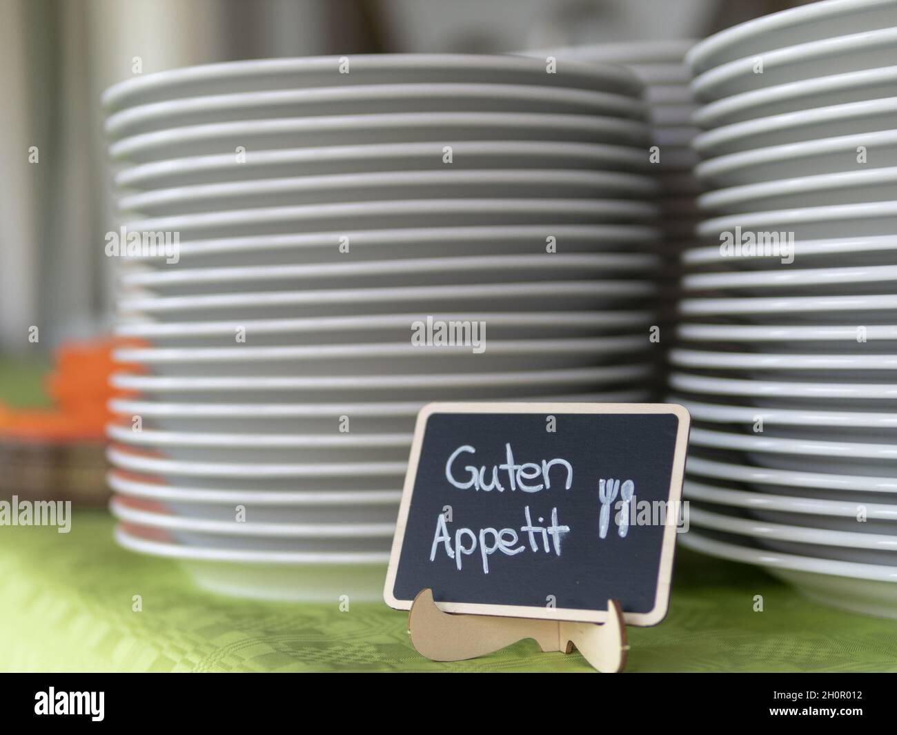 Set of plates and a sign saying 'enjoy your meal' Stock Photo Alamy
