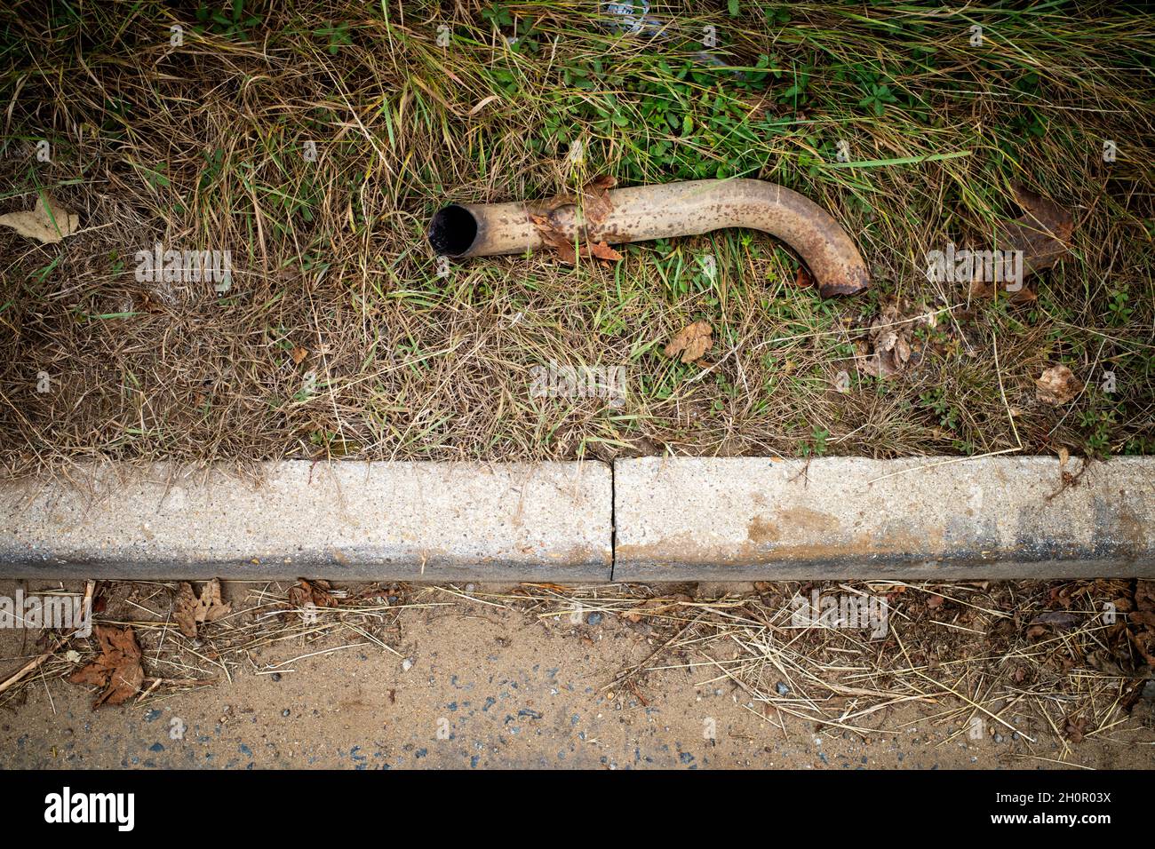Part of an exhaust system fallen off a car hires stock photography and