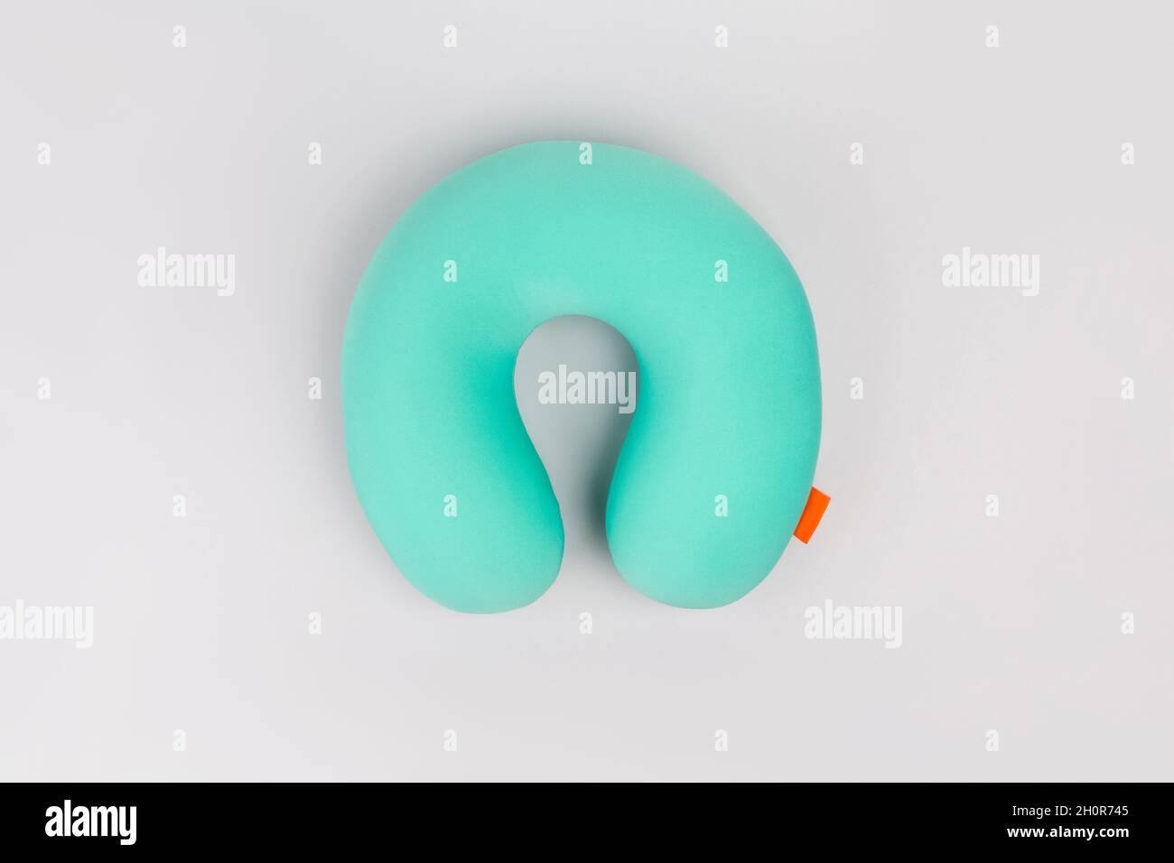Travel blue sleeping pillow or Neck Pillow on grey background. Stock Photo