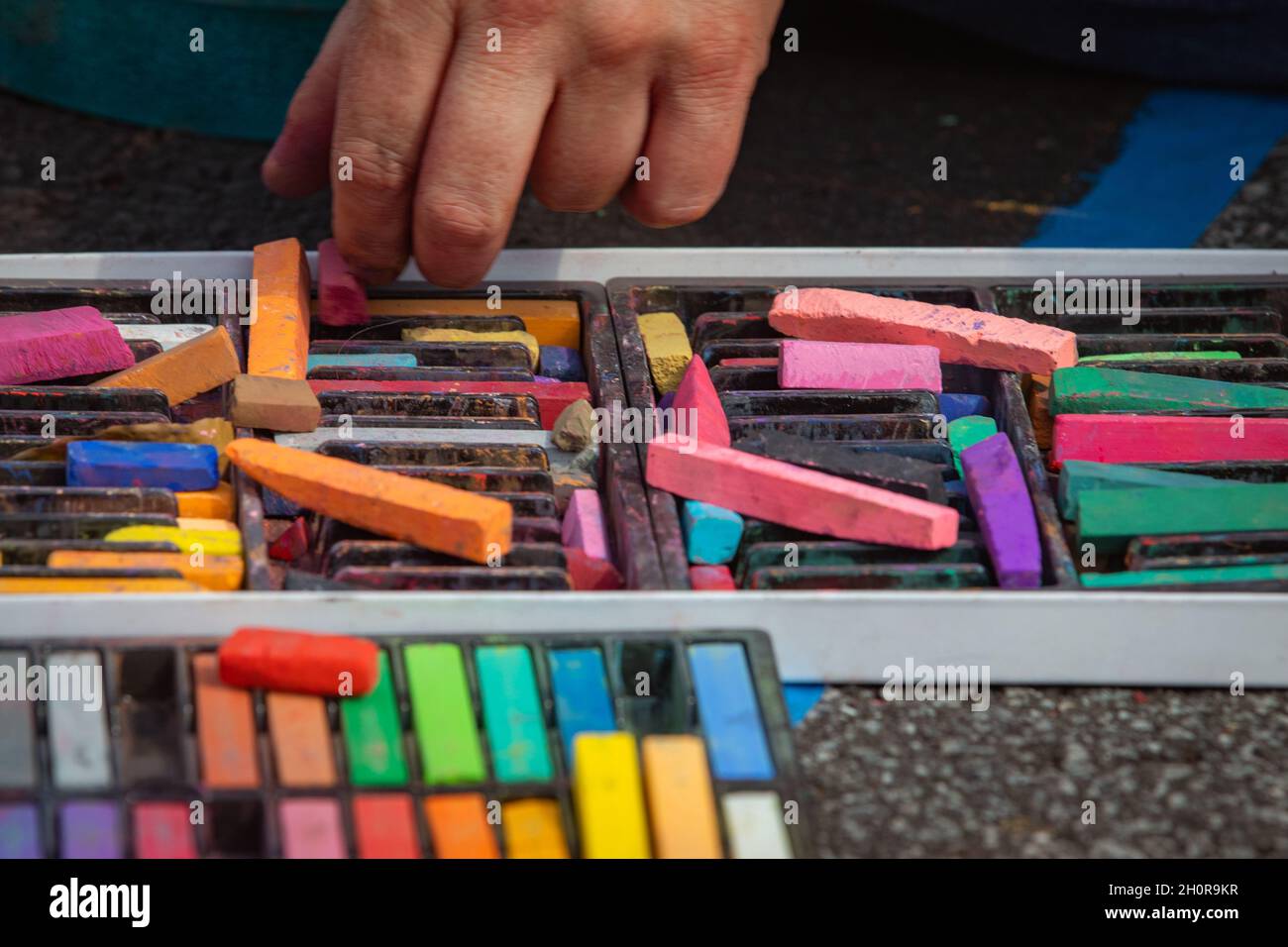Street artist picking their tool Stock Photo