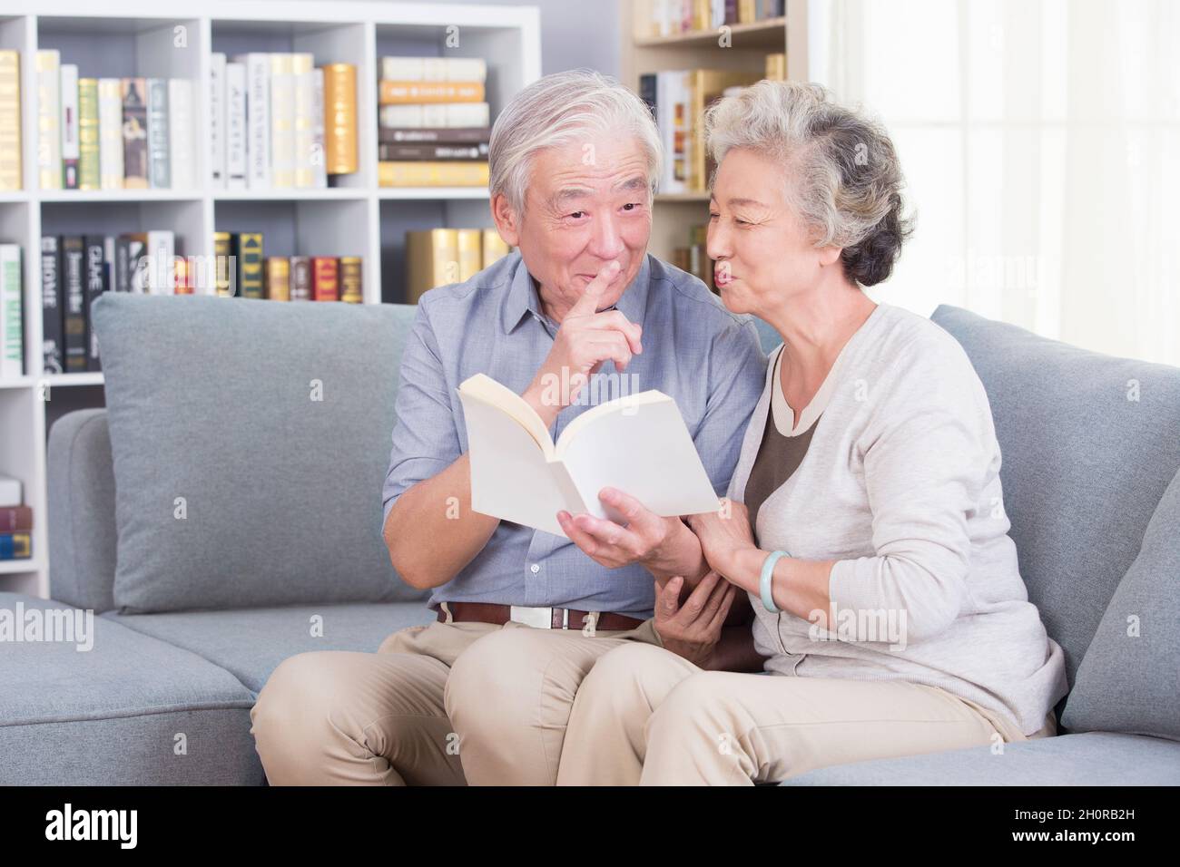 Stay-at-home elderly couple reading books Stock Photo