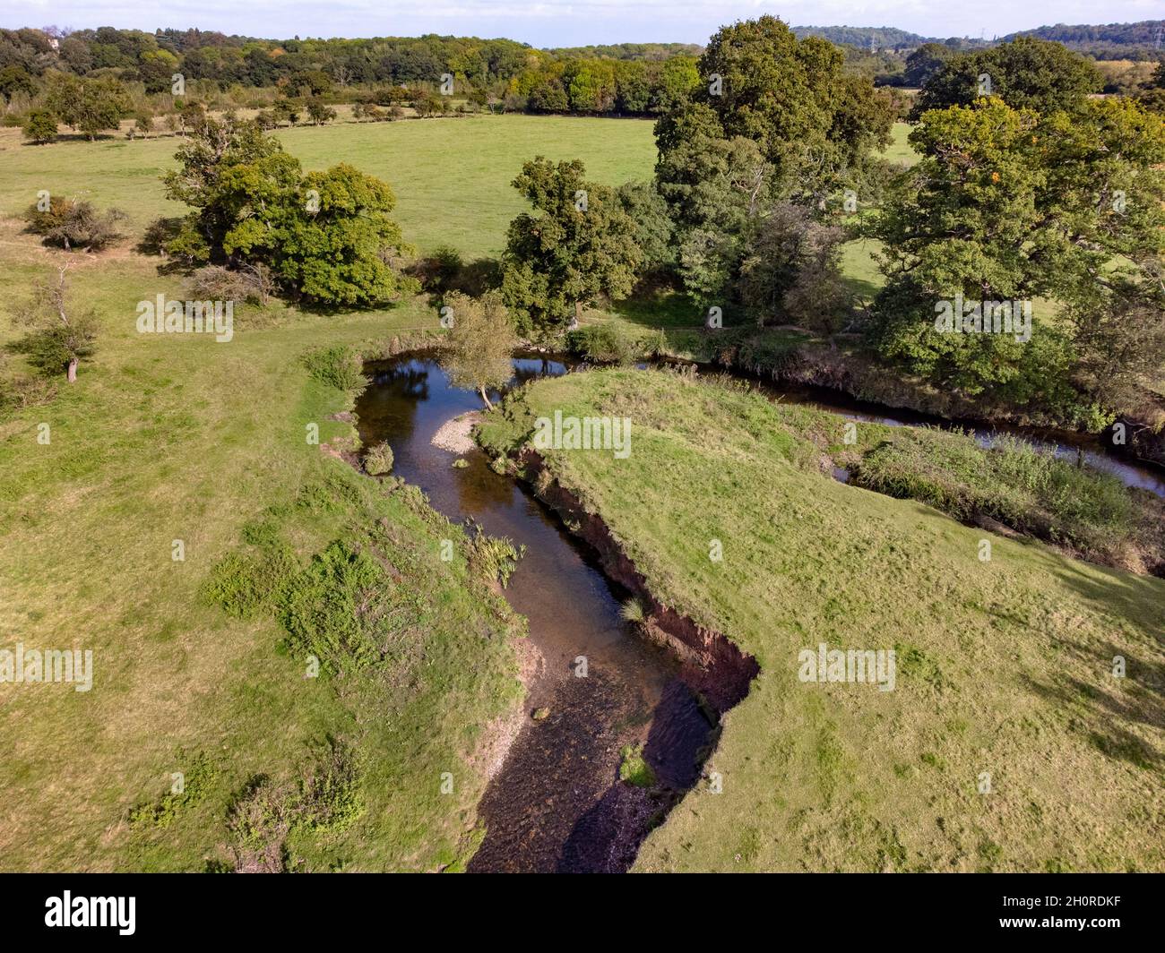 An aerial view of the small river Arrow running through farmland in Warwickshire, England. Stock Photo