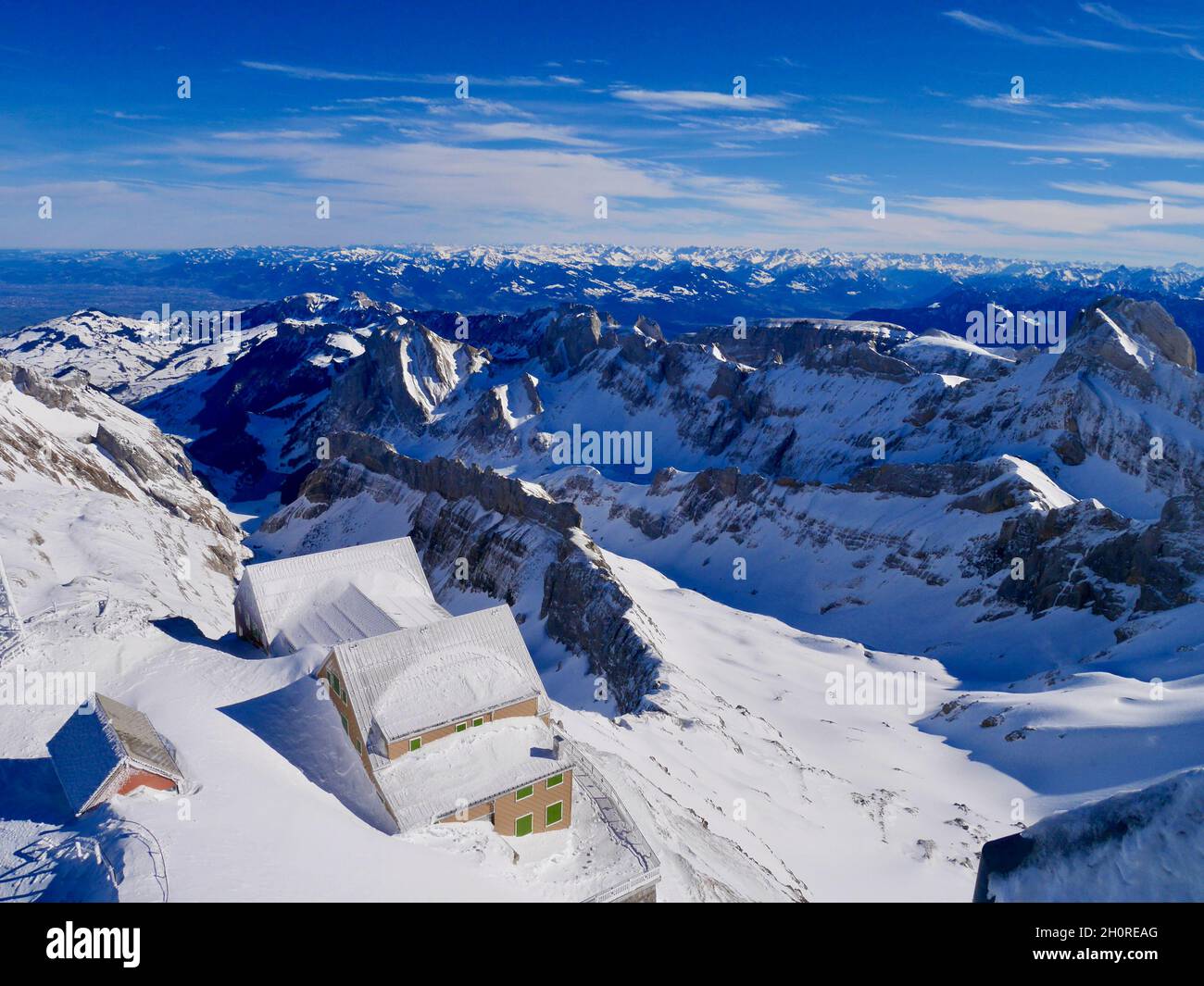 Spectacular view of Alpstein and Berggasthaus Alter Saentis seen from the mountain station of Saentis cable car. Appenzell, Switzerland. Stock Photo