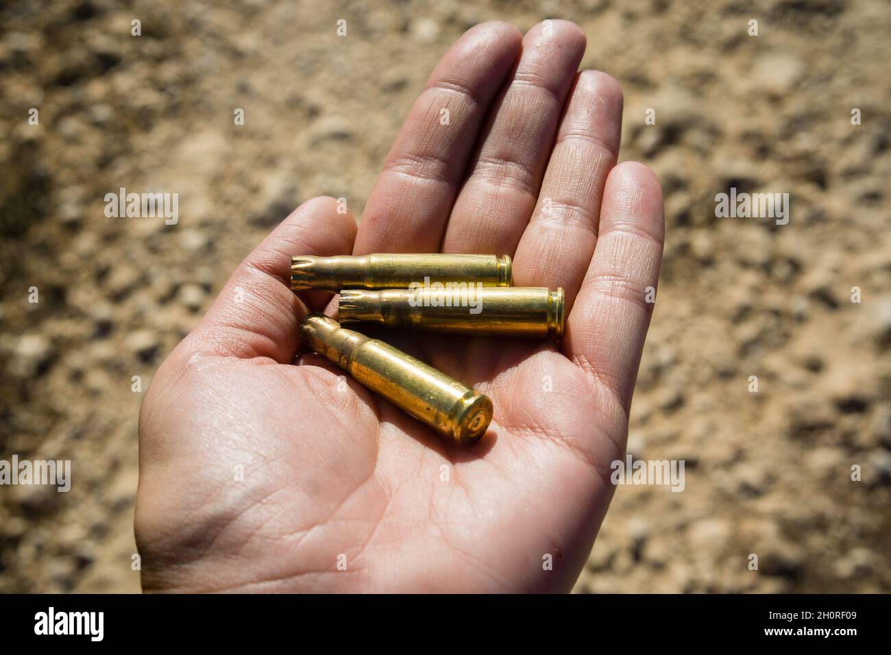 Hand full of empty shells from cartridges Stock Photo - Alamy
