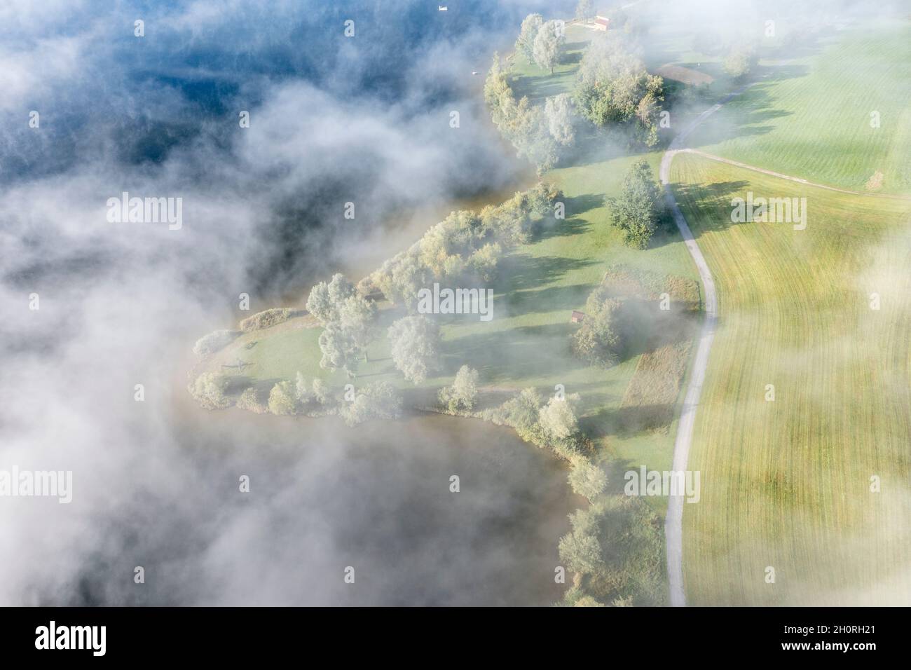 Drone shot, clouds over bathing area on small peninsula at lake Rottachsee with little hut,  Allgaeu, Bavaria, German Stock Photo