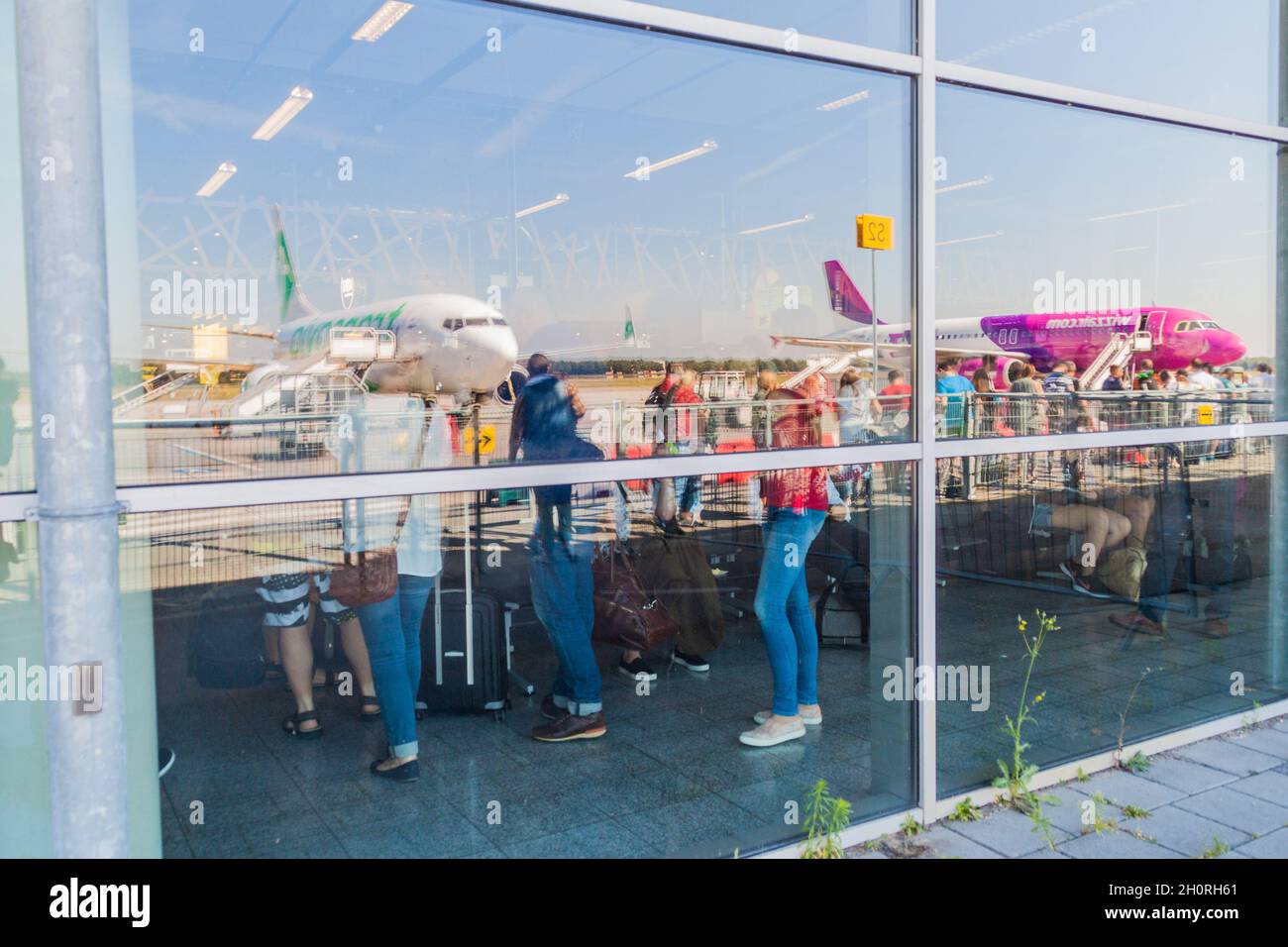 EINDHOVEN, NETHERLANDS - AUGUST 31, 2016: Reflections of airplanes at the terminal bulding of Eindhoven airport, Netherlands. Stock Photo
