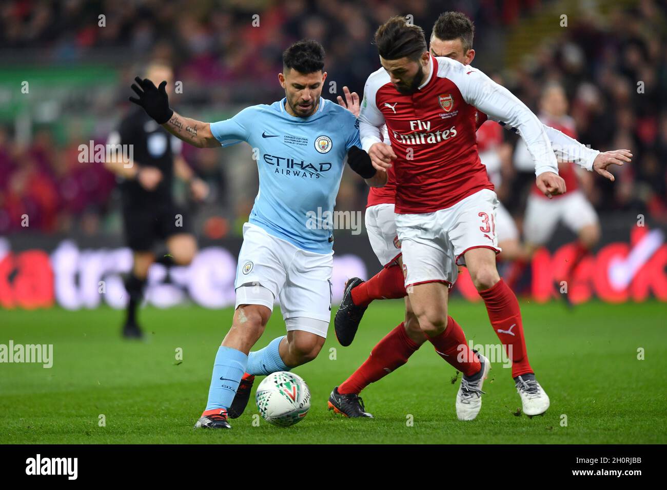 Manchester City's Sergio Aguero gets past Arsenal's Laurent Koscielny and Arsenal's Sead Kolasinac Stock Photo