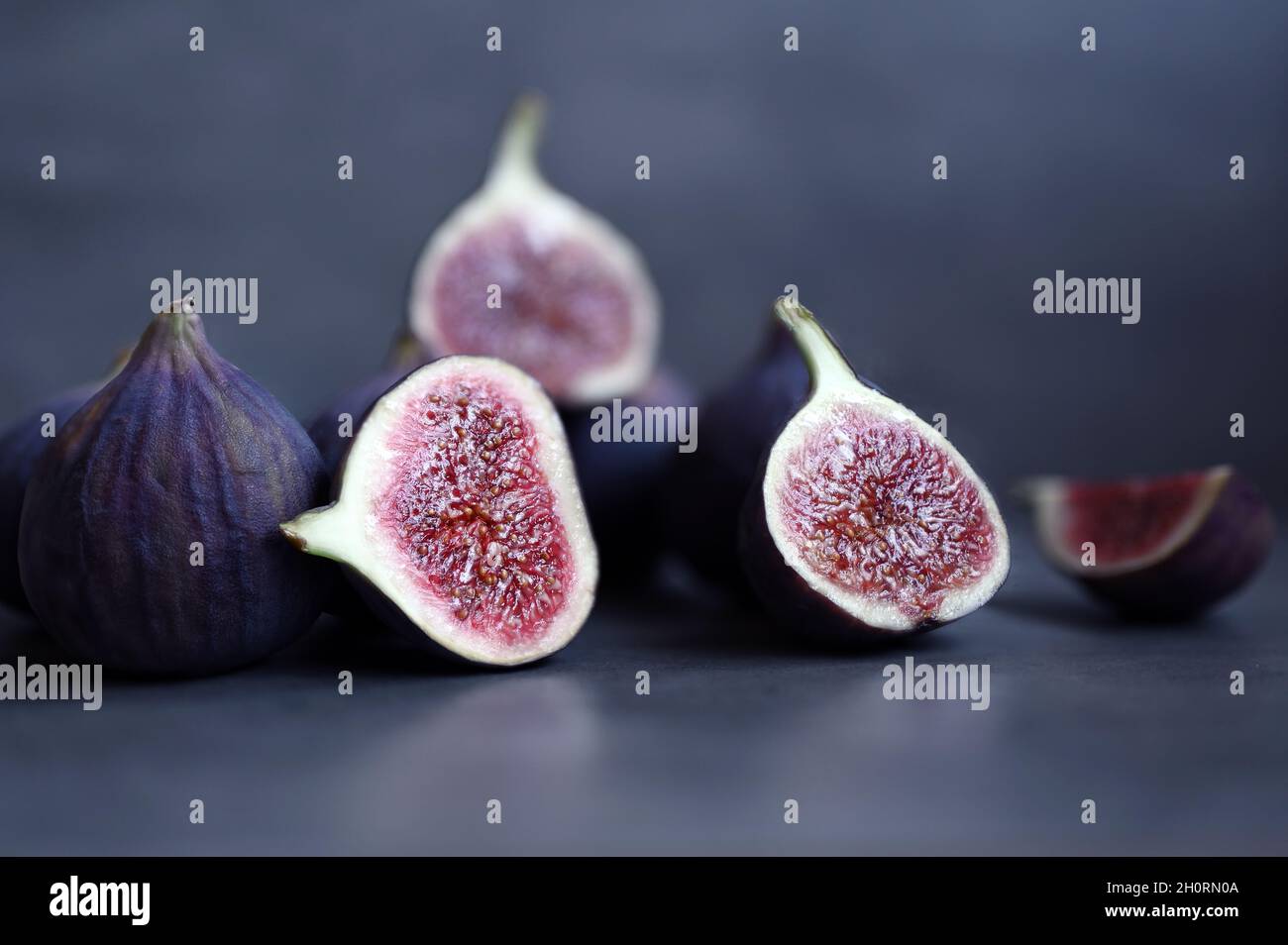 Fresh figs on violet background. Beautiful blue violet figs. Stock Photo