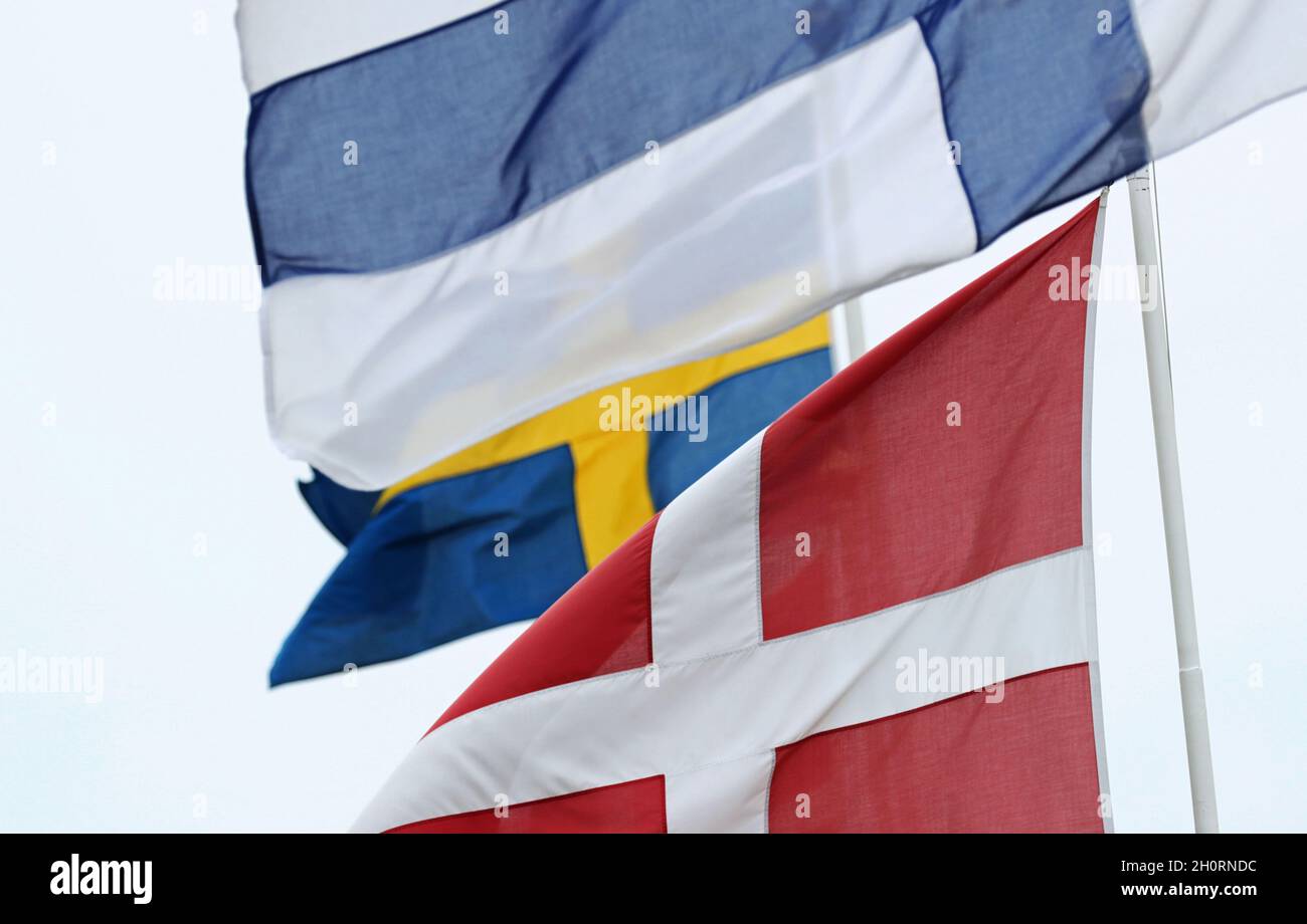 Nordic flags (the Danish flag, the Finnish flag and the Swedish flag) in Stockholm, Sweden, during Sunday afternoon. Stock Photo