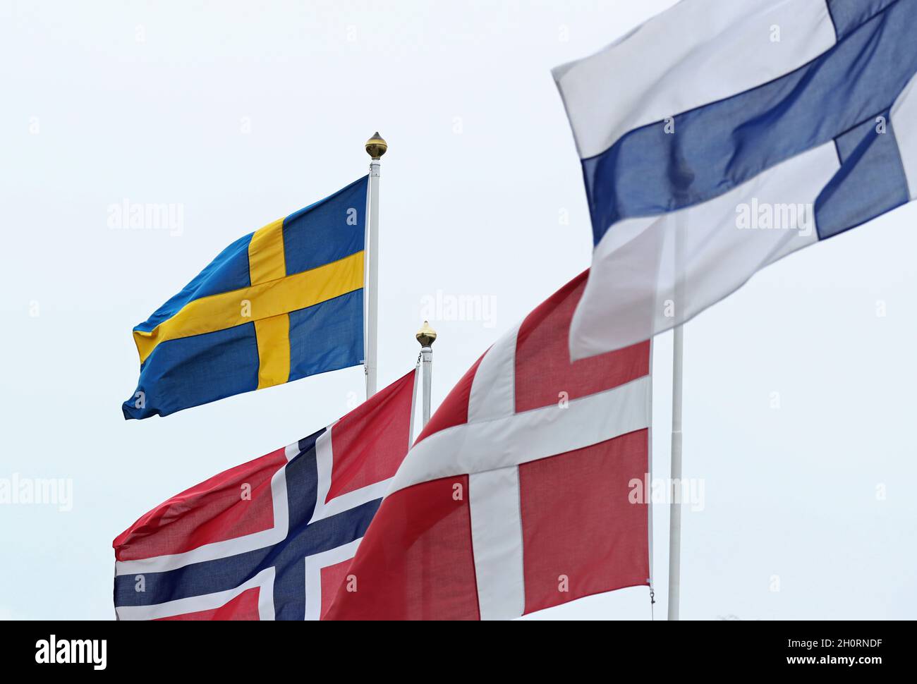 Nordic flags (Swedish flag, the Norwegian flag, the Danish flag and the Finnish flag in the foreground) in Stockholm, Sweden, during Sunday afternoon. Stock Photo