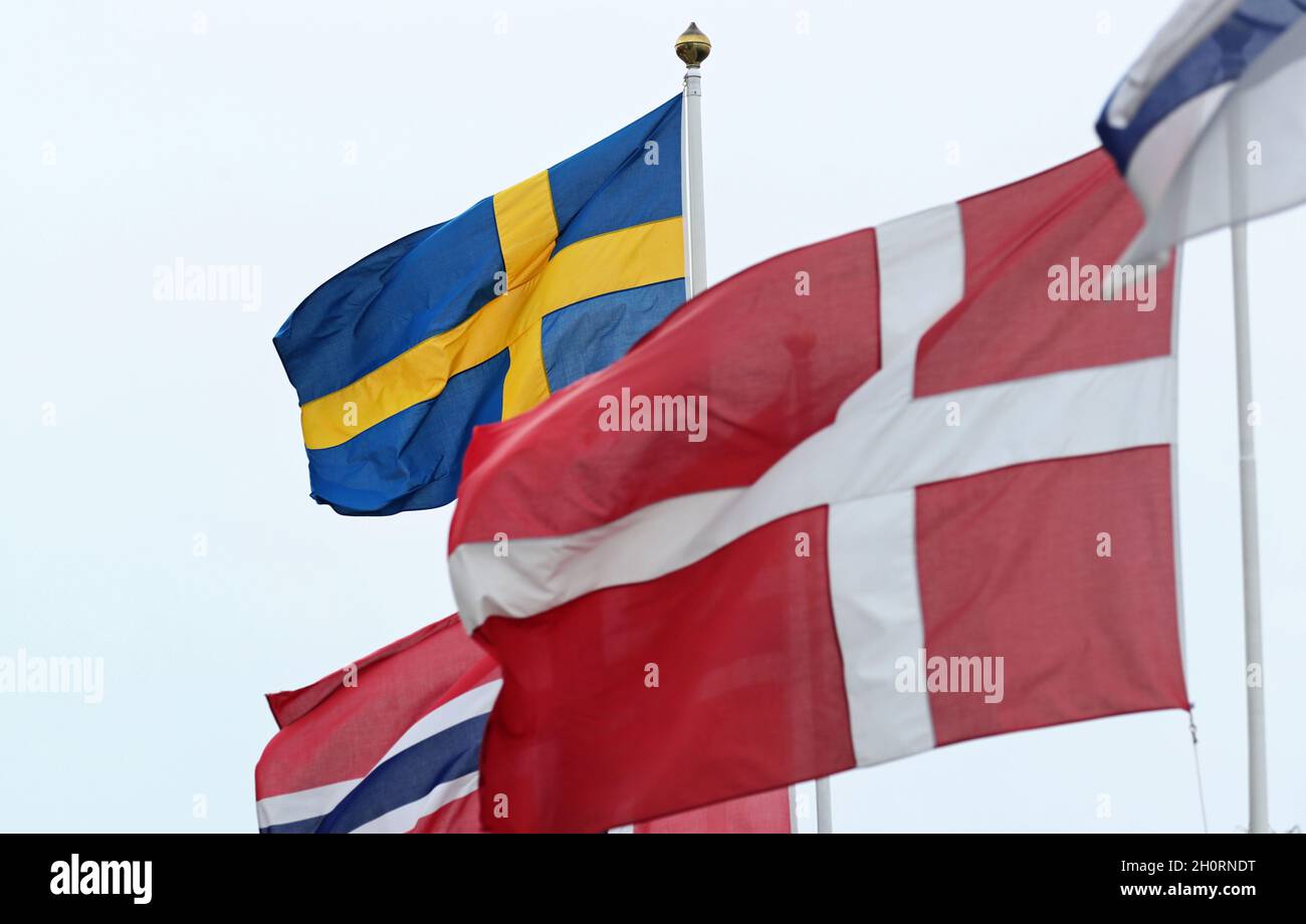 Nordic flags (Swedish flag, the Norwegian flag and the Danish flag in the foreground) in Stockholm, Sweden, during Sunday afternoon. Stock Photo