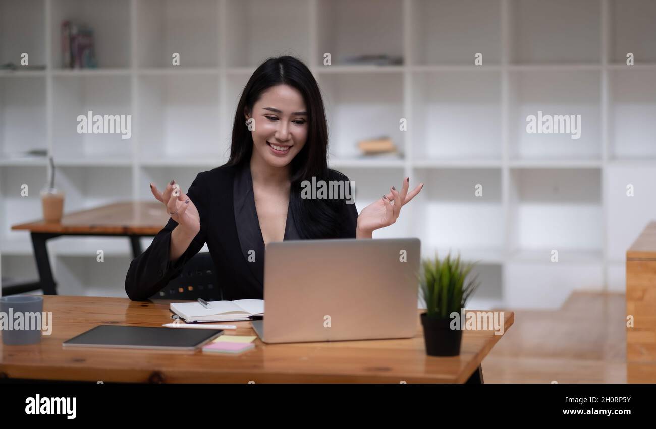 Happy asian woman communicate by video call on computer working from ...