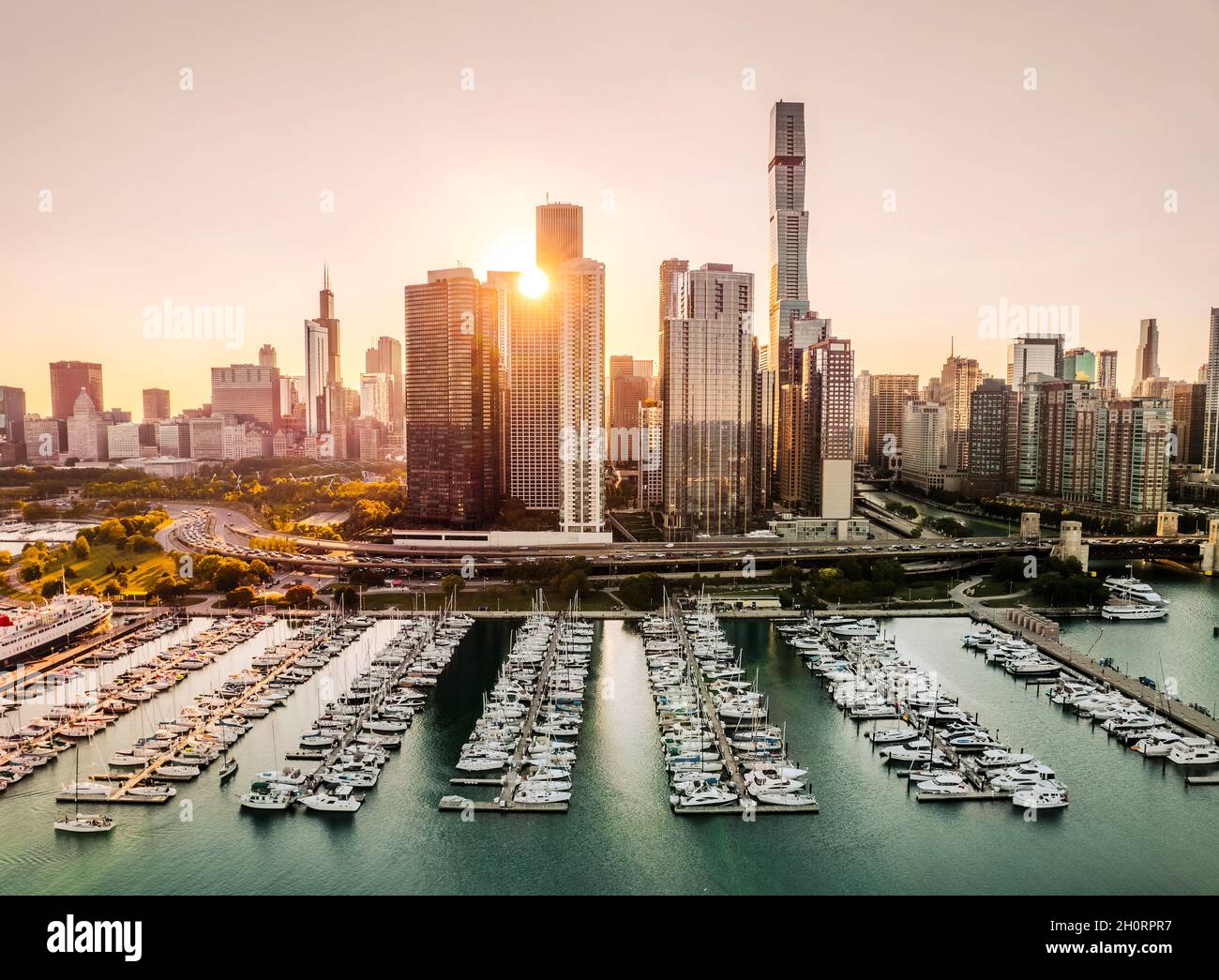 Aerial view of city skyline and boats in marina at sunset, Chicago, Illinois, USA Stock Photo