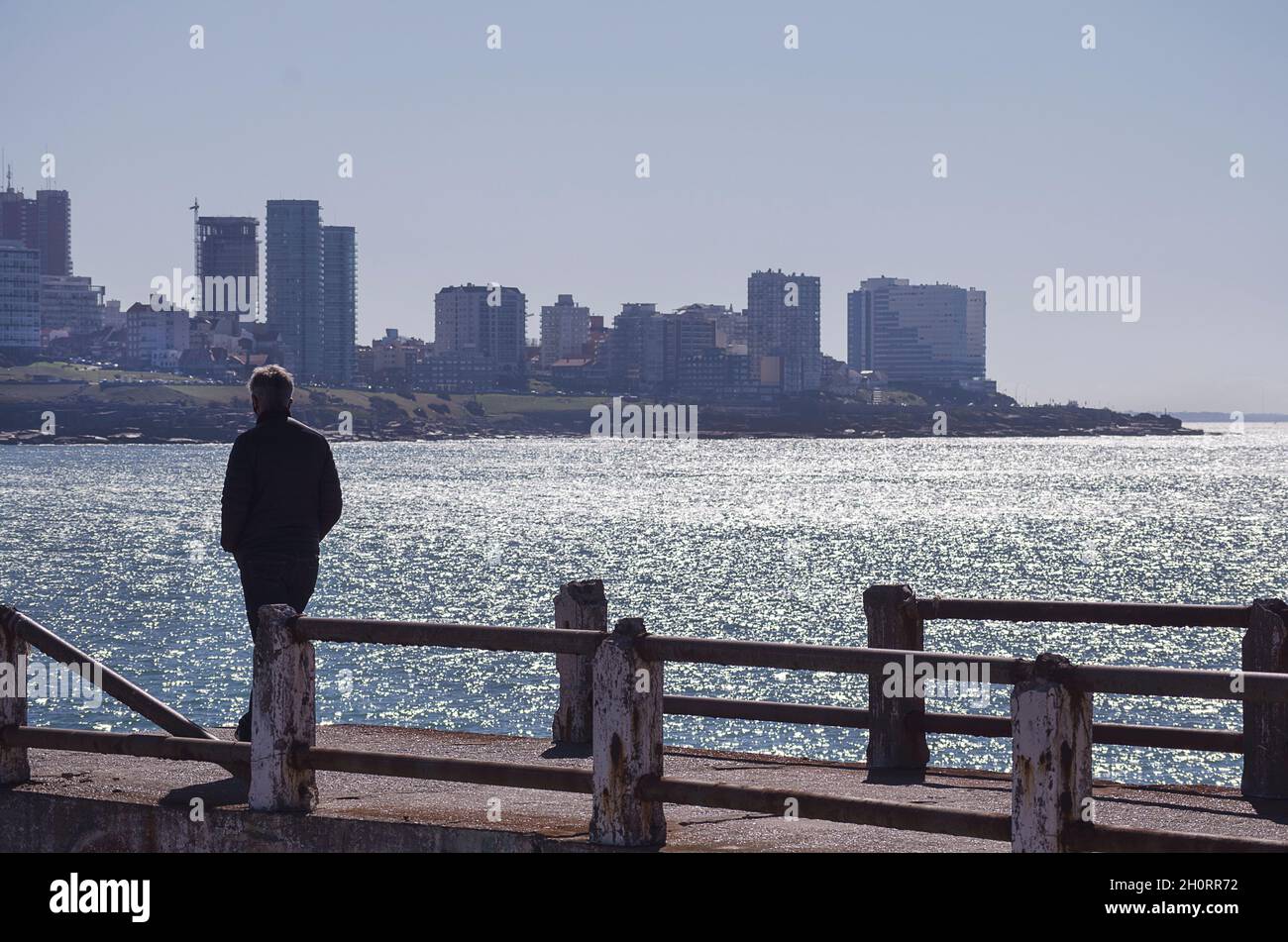 Man walking along pier, Mar del Plata, Buenos Aires Province, Argentina Stock Photo