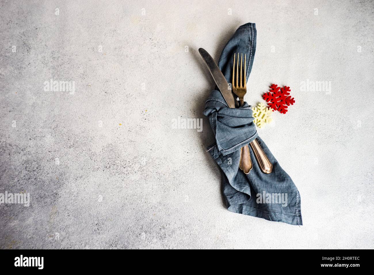 Cutlery wrapped in a napkin with snowflake decorations Stock Photo