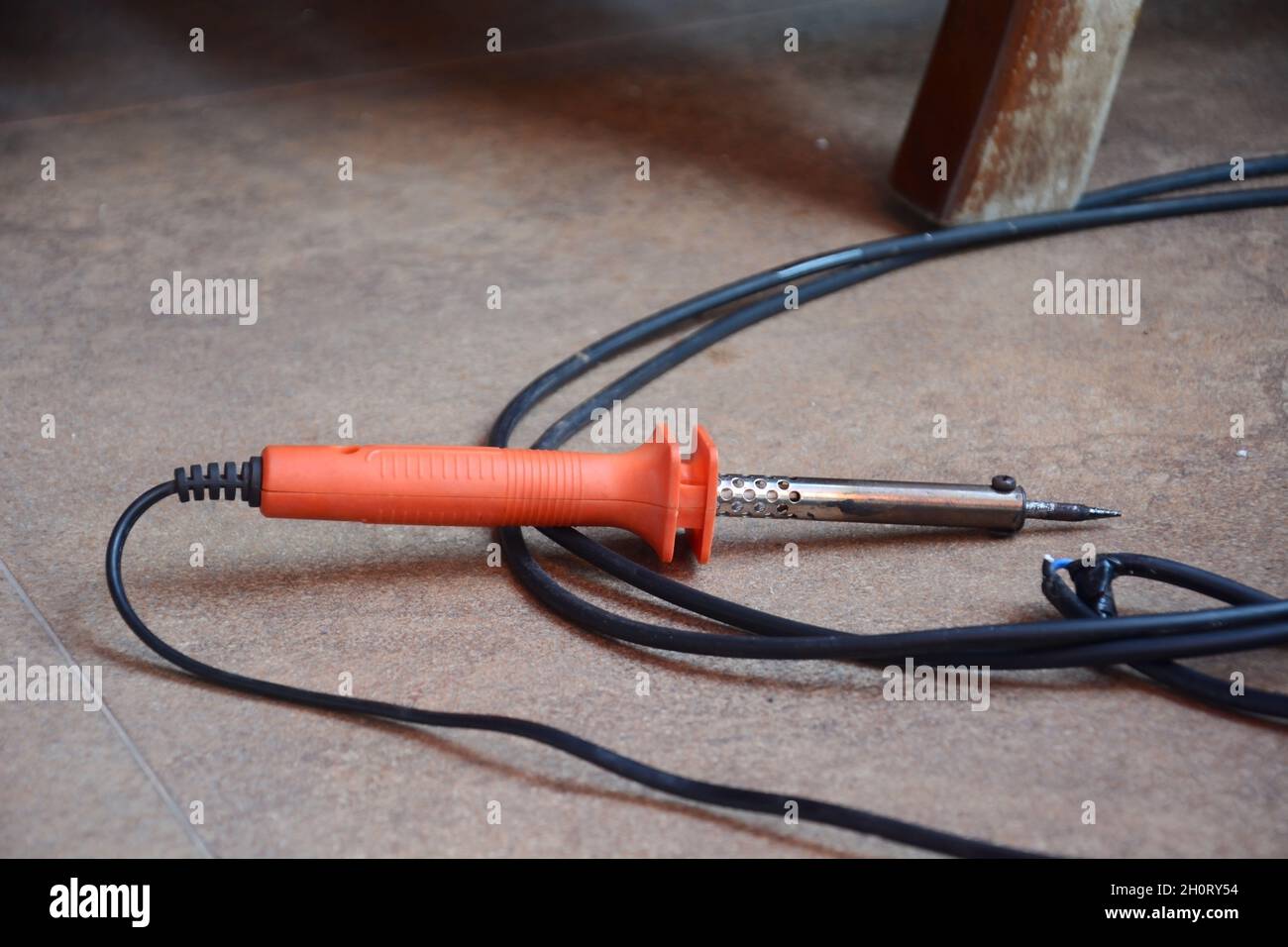electric soldering iron with orange handle and black wire Stock Photo Alamy