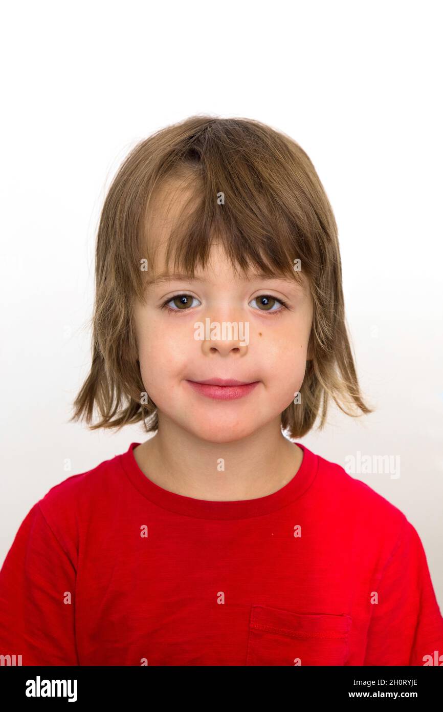 5 five years old photo for passport or ID card. Emotionally grimacing little boy with blond hair and bright green eyes white background Stock Photo