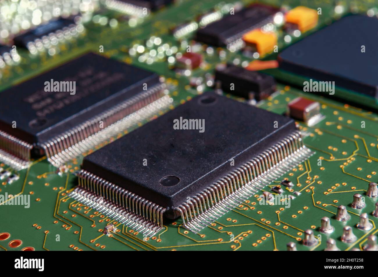 printed circuit board with surface mounted passive and active circuit components close up Stock Photo