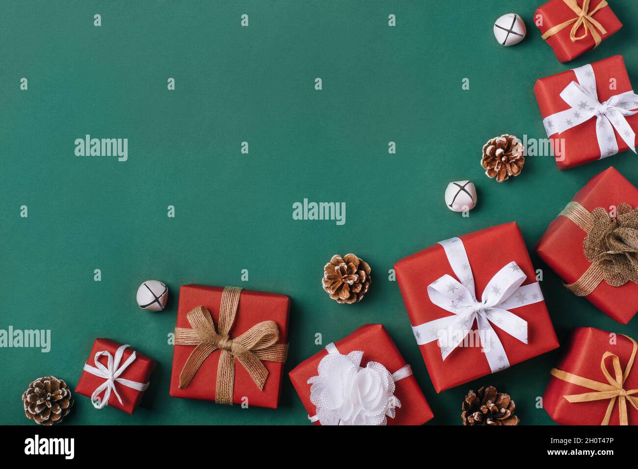 Gift boxes with white and brown bows on a green backdrop. Stock Photo
