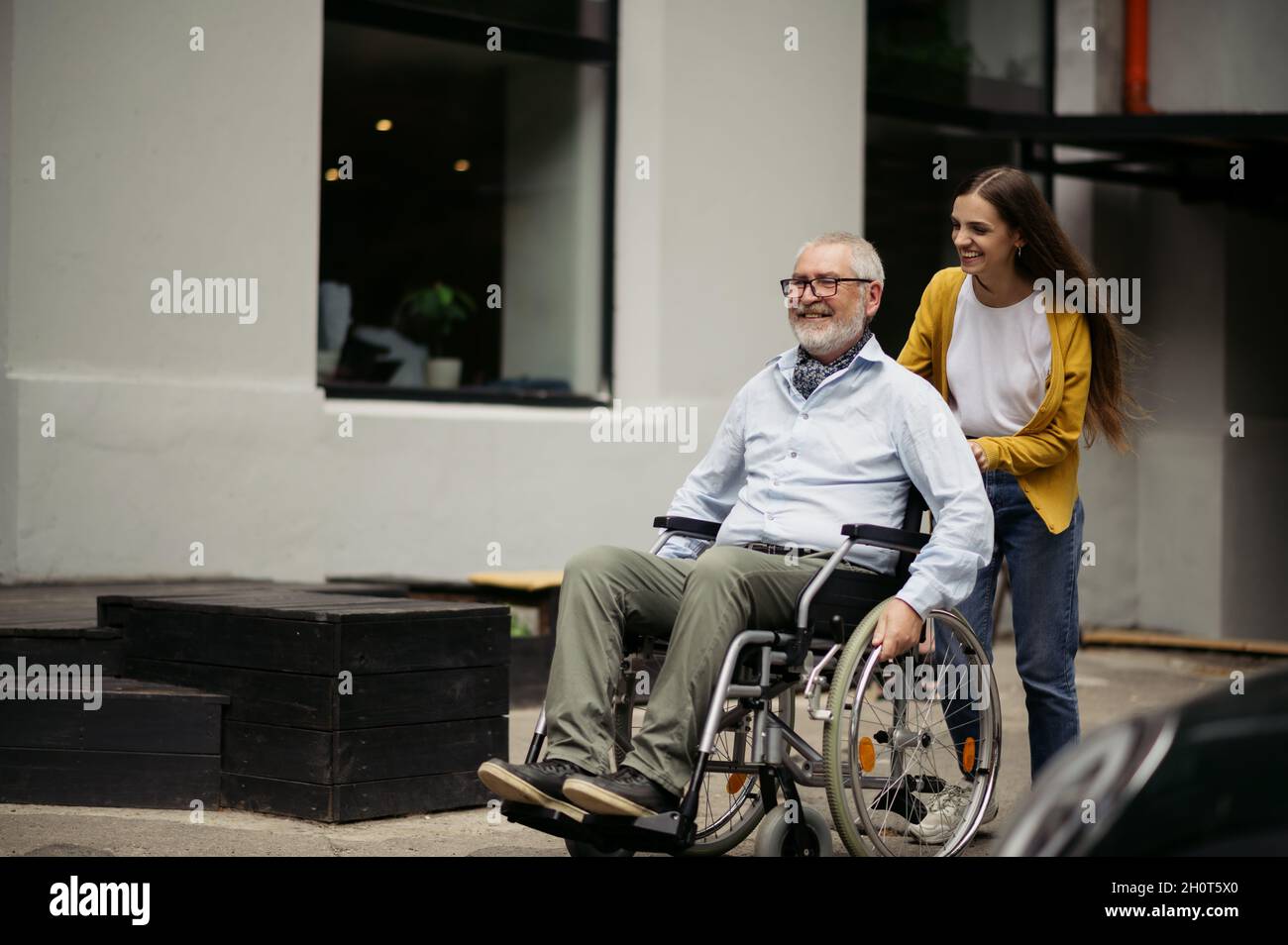 Daughter and disabled father go for a walk Stock Photo