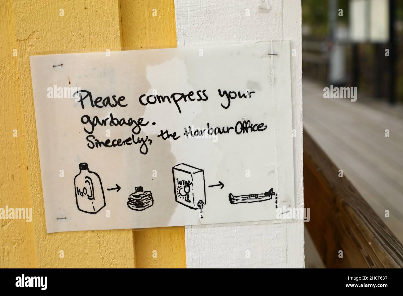 Sign about waste management in the harbor at Djurgården in Stockholm, Sweden, during Sunday afternoon. Stock Photo