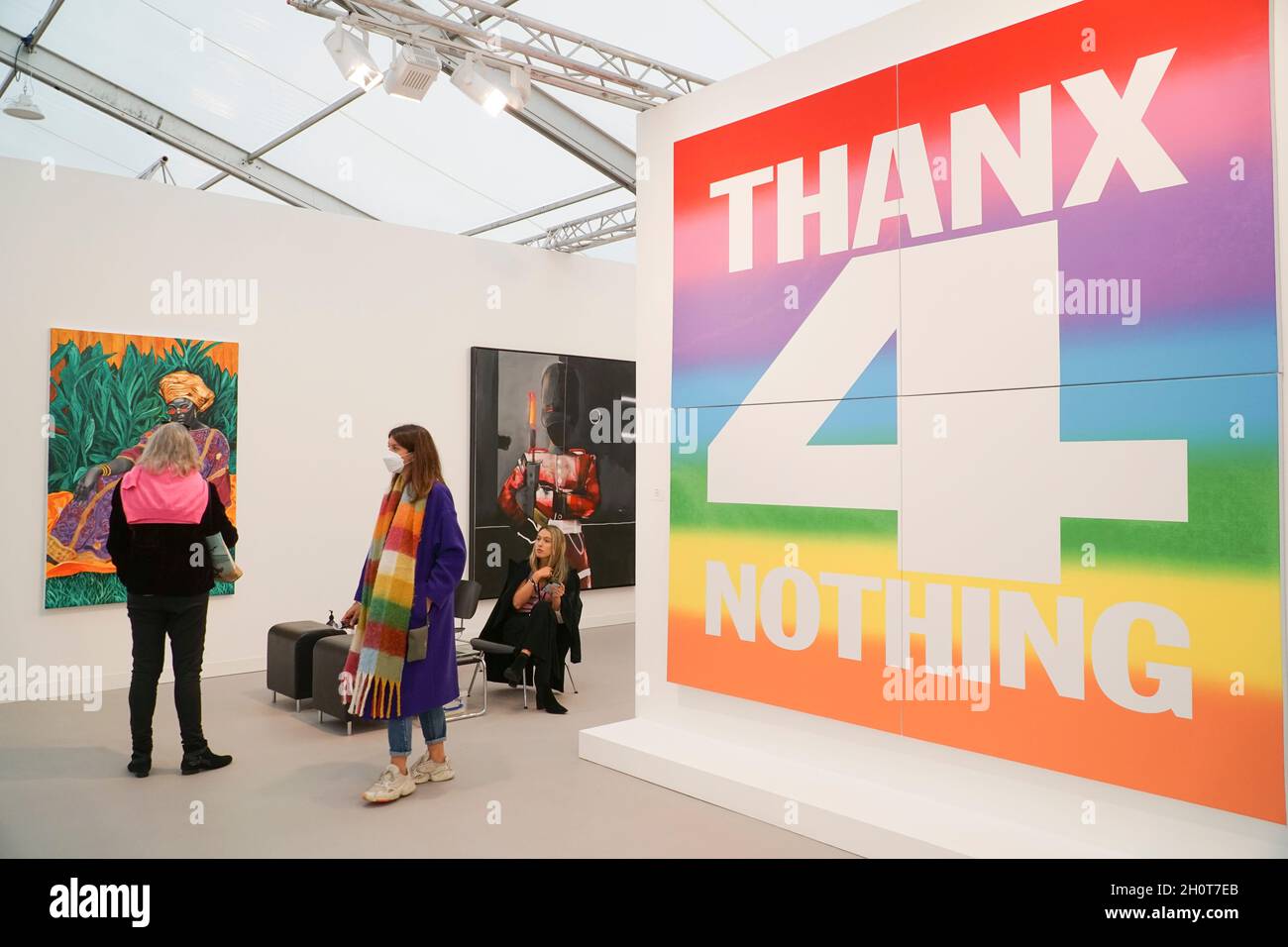 London, UK, 14 October 2021: Frieze art fair opens in London with contemporary art from around the world. 'Thanx 4 Nothing,' 2019, by John Giorno, dominates the eye with it's ranbow colours. The show has an emphasis on averting climate catastrophe both in the works shown and in the reduced carbon footprint of the fair compared to previous years. Anna Watson/Alamy Live News Stock Photo